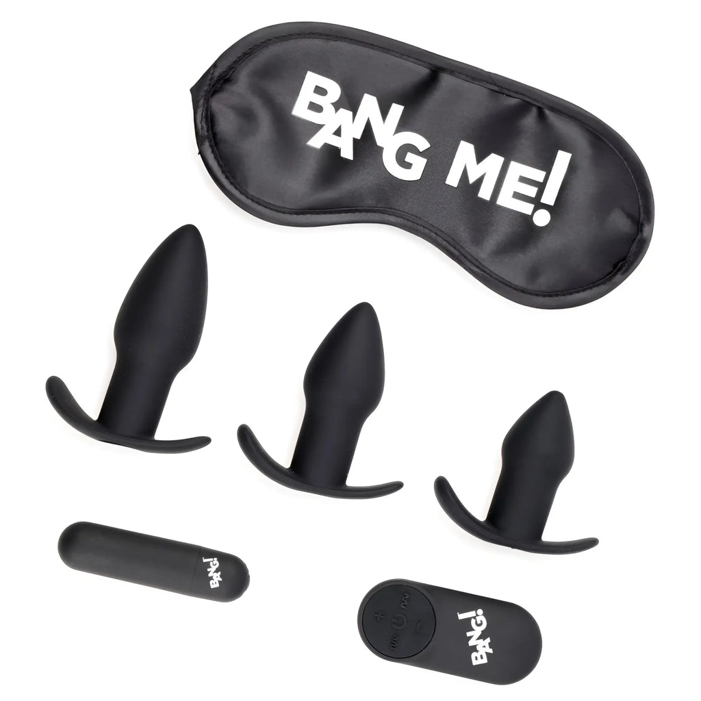 Bang Backdoor Adventure kit with three black silicone butt plugs, a matching remote, and a "BANG ME!" sleep mask.