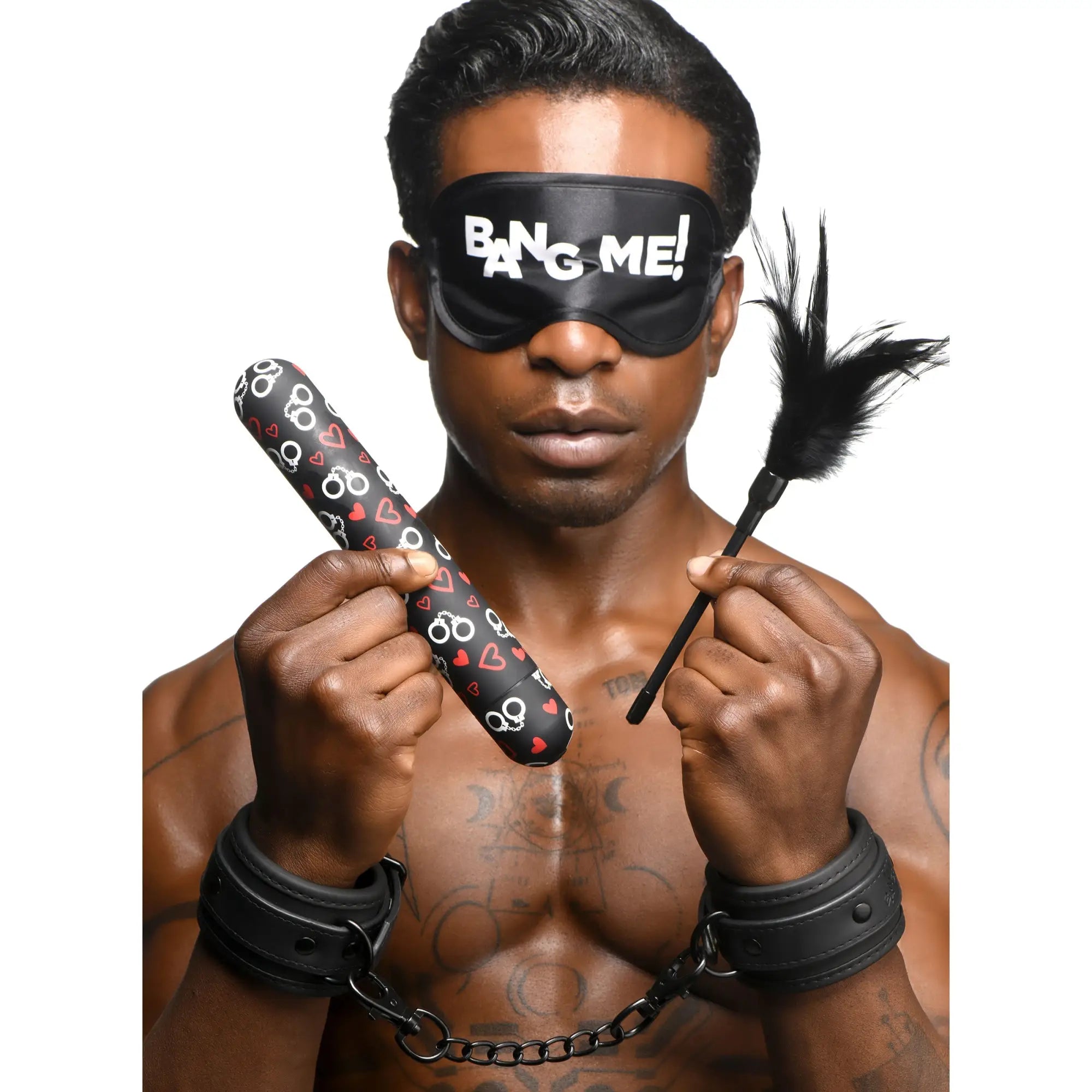 Bang bondage kit featuring a black blindfold with white bang me text and a black feathered wand held by a man in handcuffs