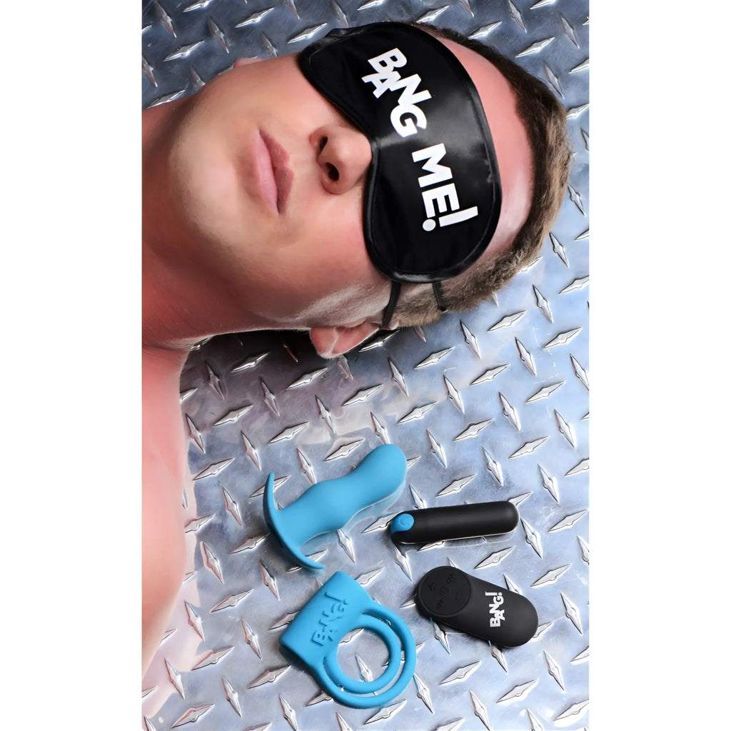 Bang Duo Blast kit featuring a blue butt plug, cock ring, and black remote, with a man wearing a "Bang Me" blindfold.