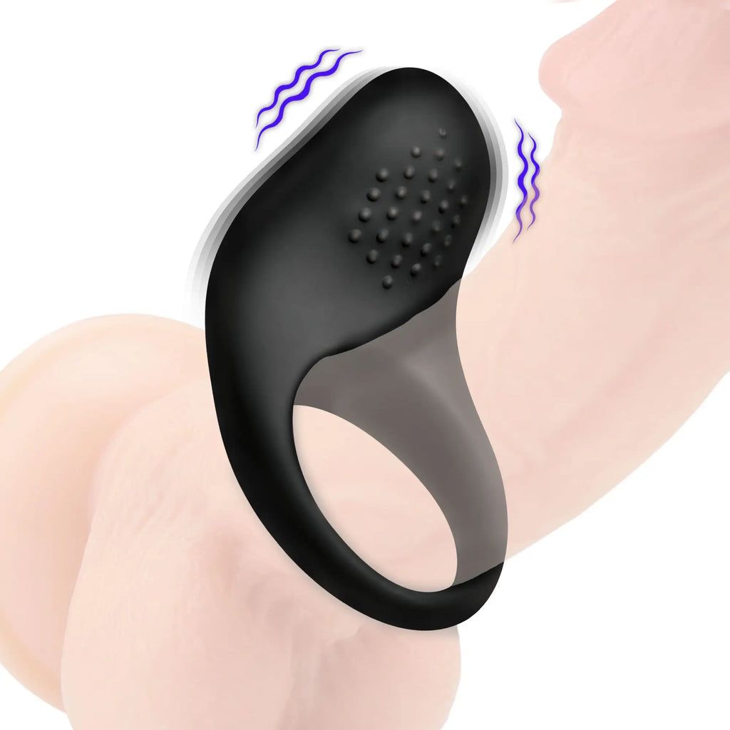 Bang vibrating silicone cock ring in matte black with textured nubs on a phallic model, shown with motion blur.