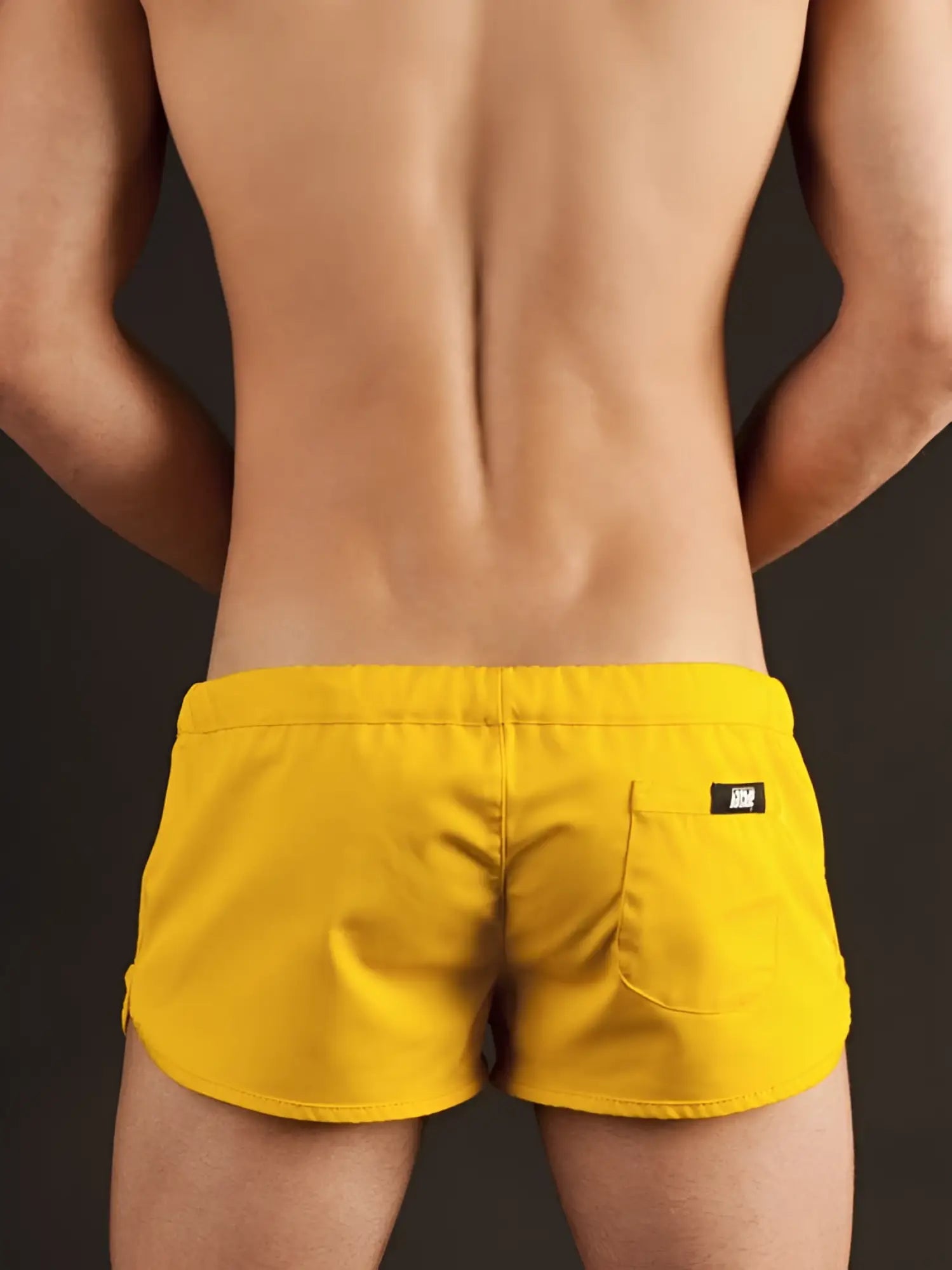 Bright yellow Barcode Berlin gym shorts xl showing back side with sleek modern design and small black brand tag on pocket