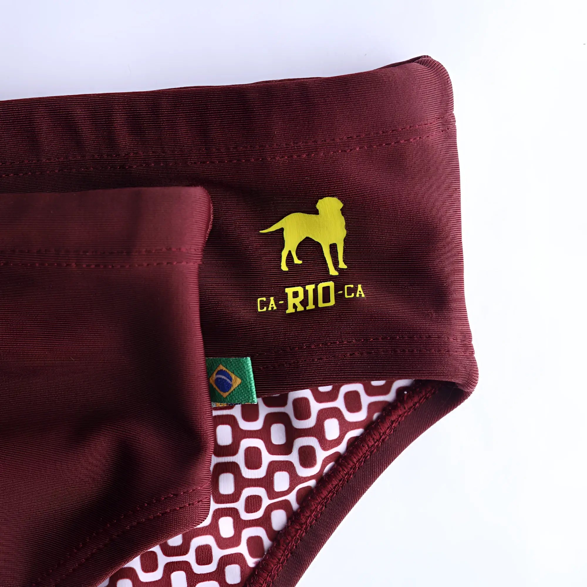 Barolo burgundy solids men’s swimming sunga in maroon with yellow dog logo and white geometric interior pattern
