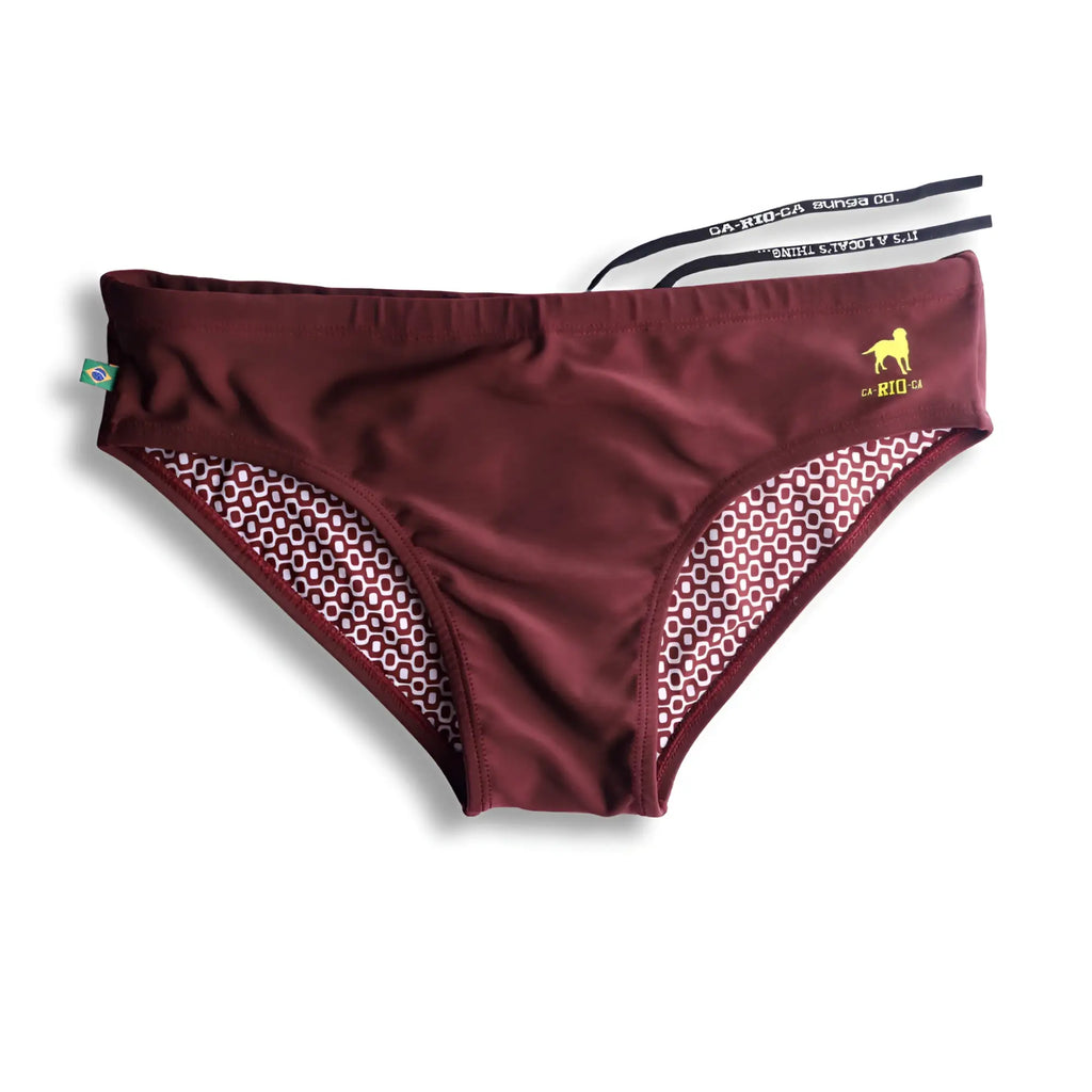 Burgundy CA-RIO-CA sunga featuring a yellow logo, Brazilian flag tag, and a geometric patterned interior.