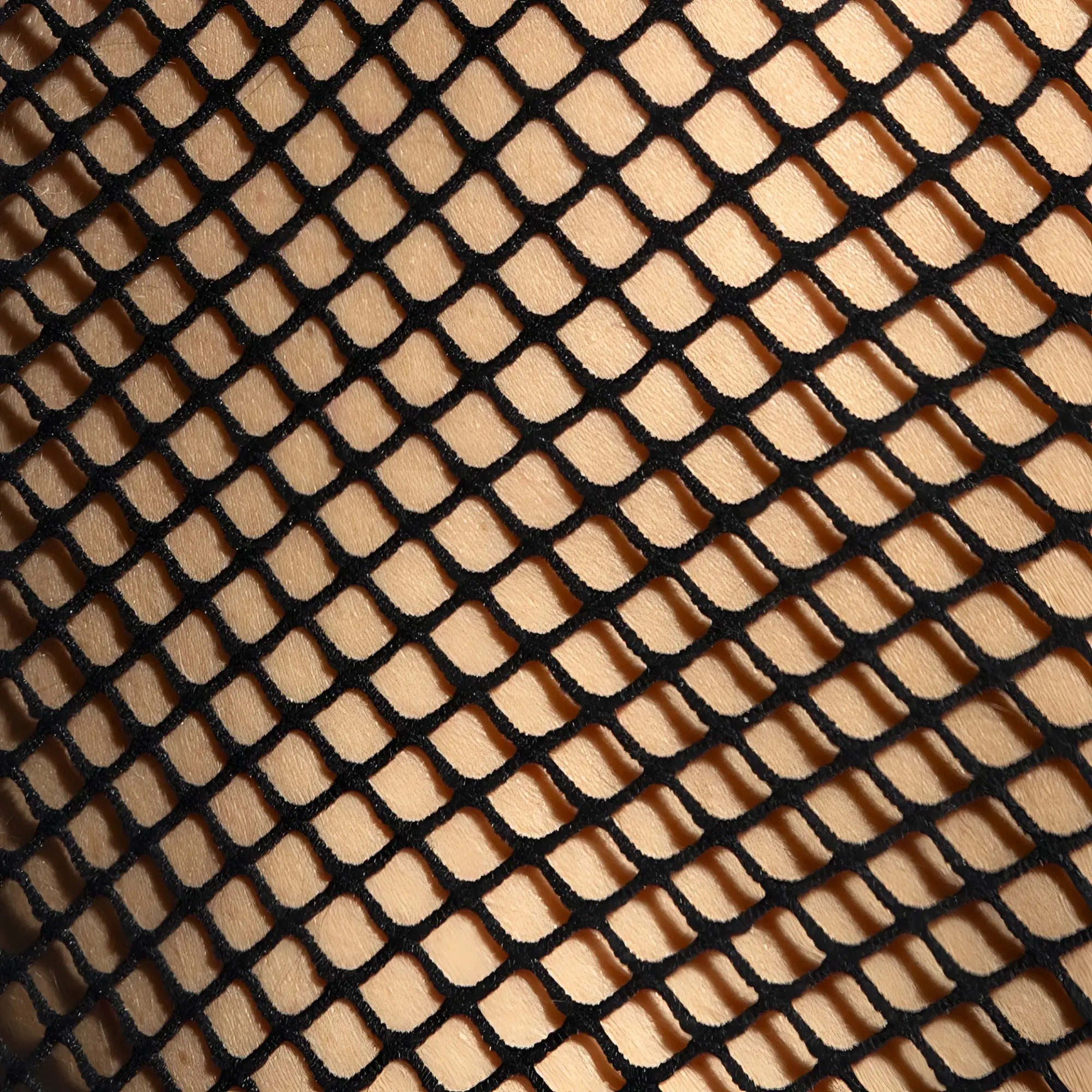 Black fishnet fabric with diamond mesh pattern highlighting the beachy net strap tank top material and design