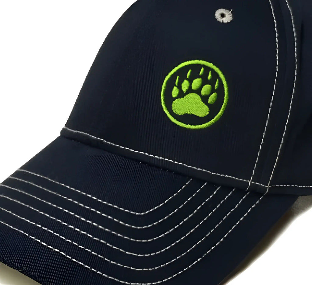 Bear paw logo cap navy featuring a lime green embroidered paw print and white stitching on a dark navy baseball cap