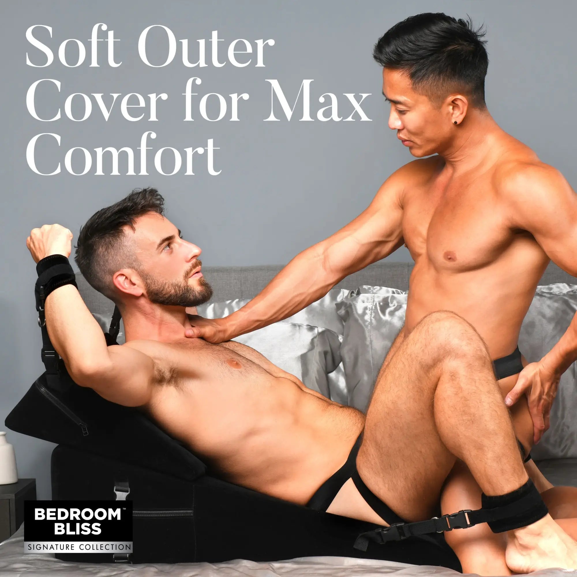 Bedroom Bliss Bondage Cushion Set: Two men on a plush black wedge pillow featuring integrated black restraint cuffs.