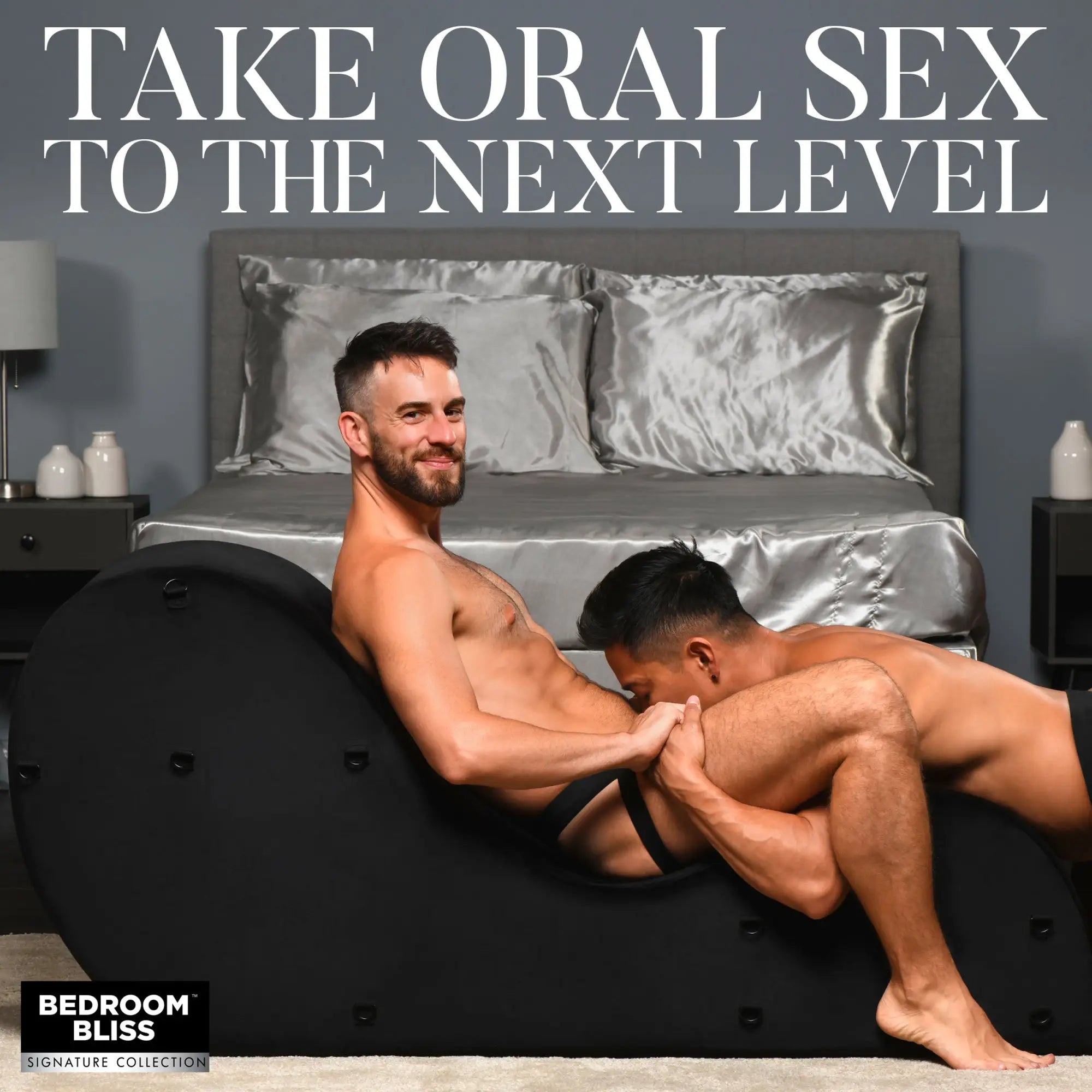 Bedroom Bliss Bondage Love Couch: A black, curved, ergonomic sex furniture piece in a bedroom. Two men are interacting.