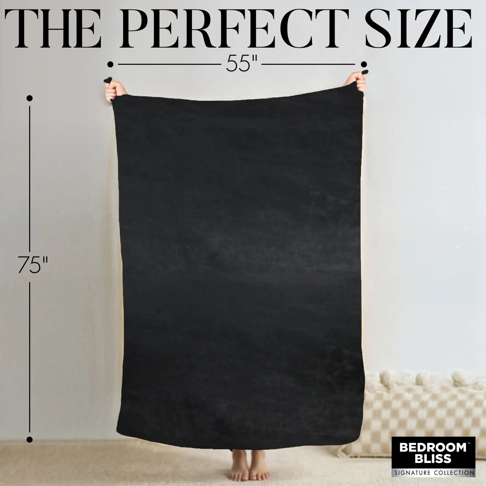 Hands holding a solid black Bedroom Bliss waterproof throw blanket, labeled with 55" by 75" dimensions.