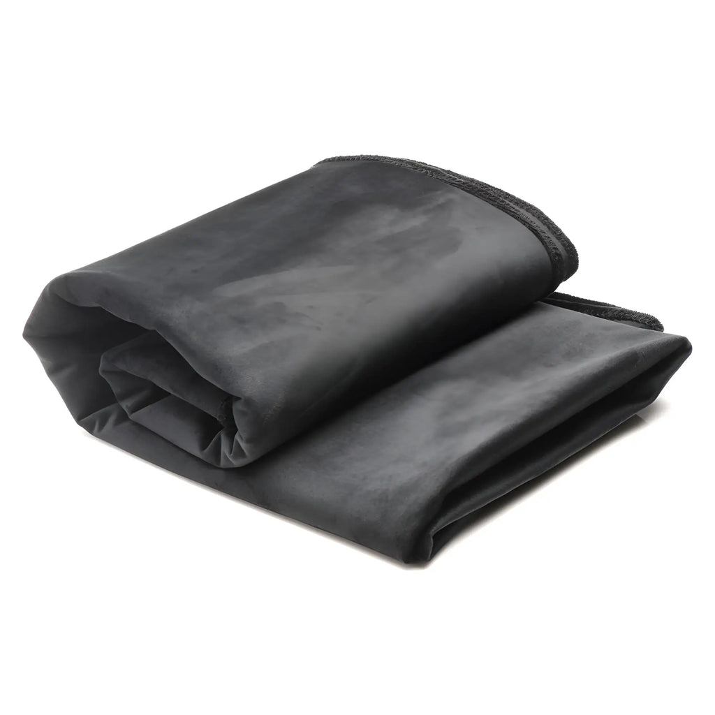 Bedroom Bliss waterproof throw blanket in a soft, folded dark grey velvet material against a white background.