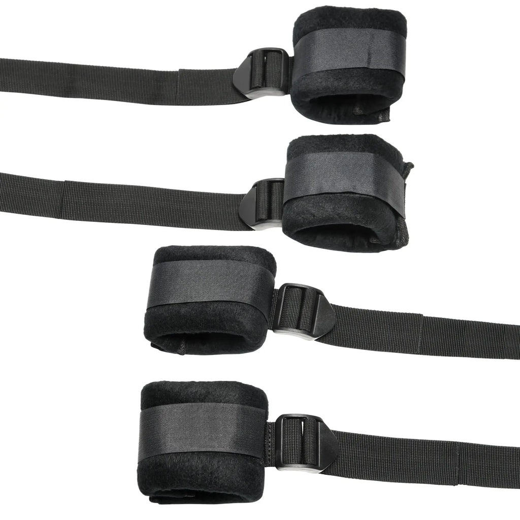 Bedroom Bliss Lover's Bed Restraint System: Four black padded cuffs with adjustable nylon straps and plastic buckles.