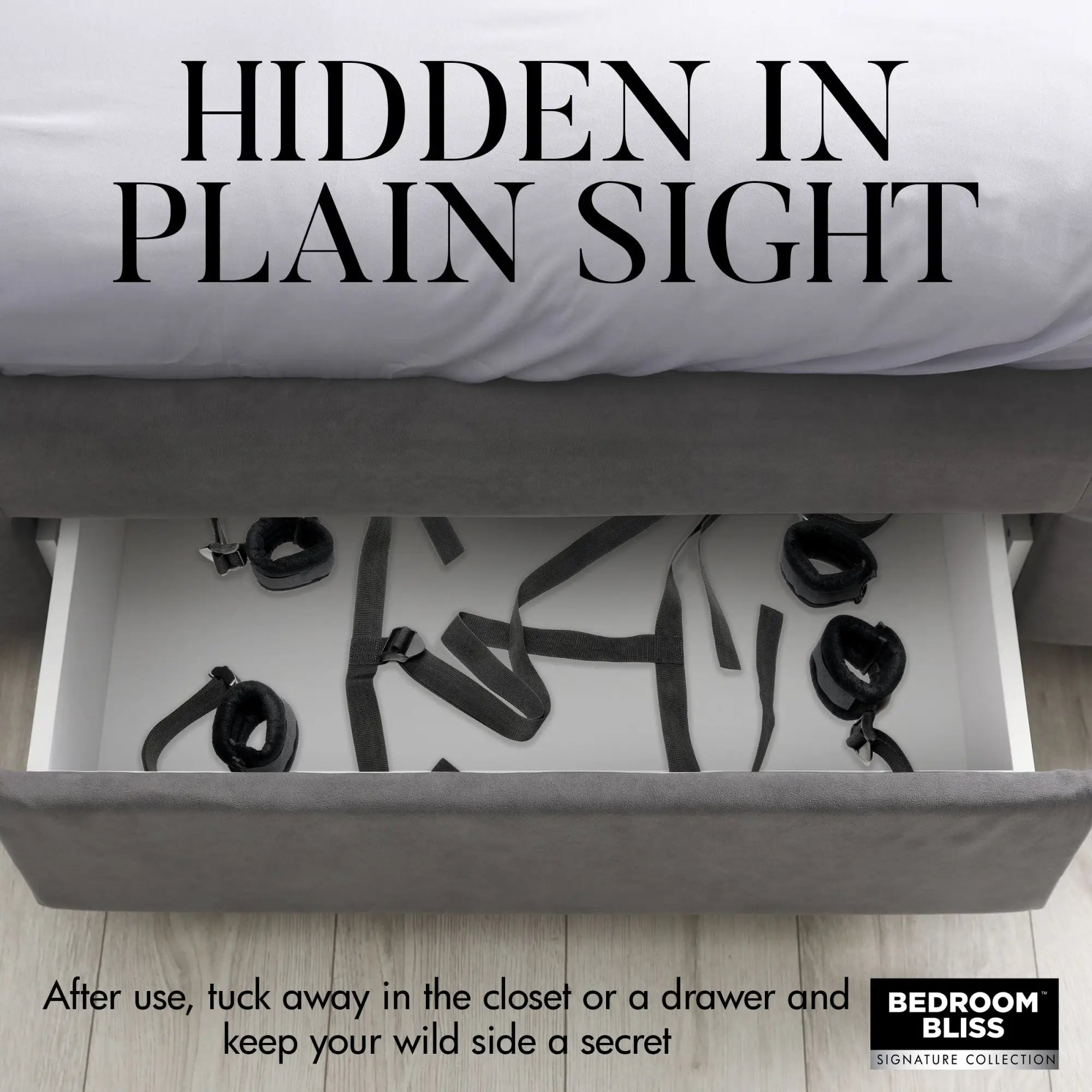 Bedroom Bliss Lover's Bed Restraint System: Black fabric restraints stored neatly inside an open grey bed frame drawer.