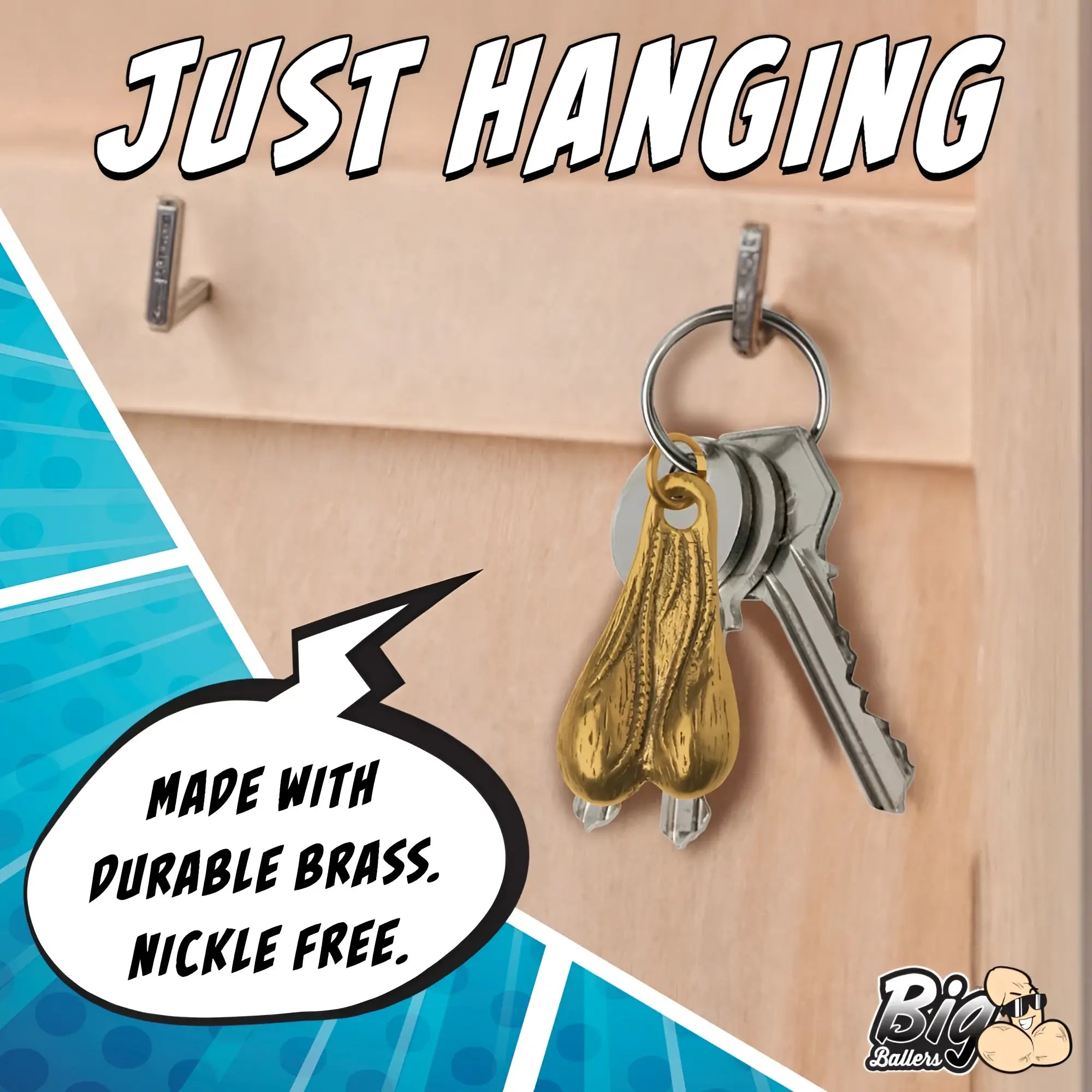 Big Ballers Brass Nuts keychain hanging on a wall hook with keys, featuring a realistic metallic gold testicle charm.