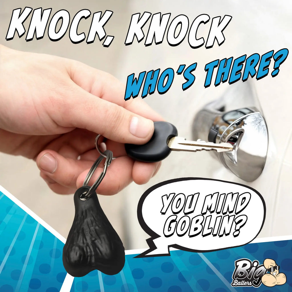 Big Ballers keychain: A black, realistic-textured novelty accessory held by a hand inserting a car key into a lock.