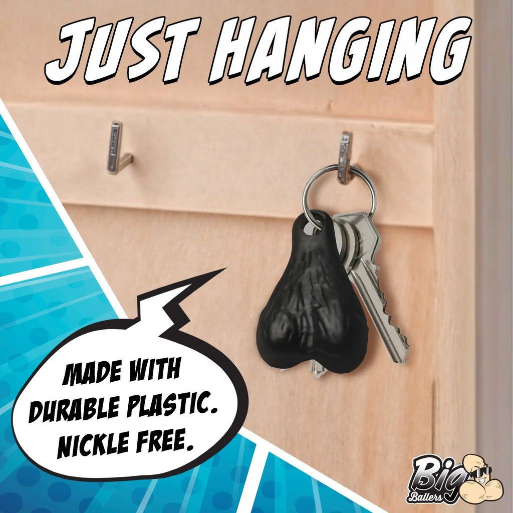 Big Ballers keychain: A black, realistic, testicle-shaped charm hanging on a key ring with metal keys.