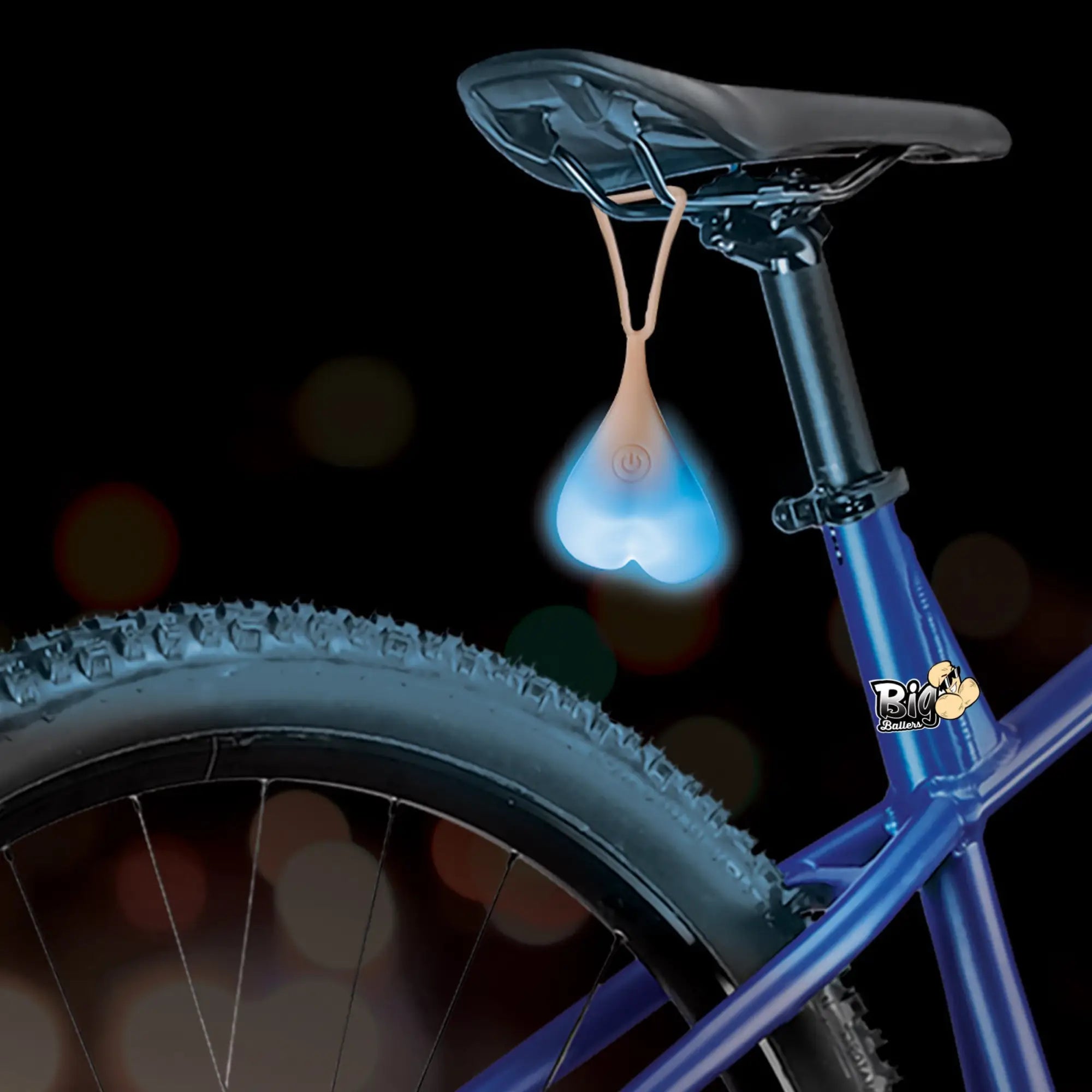 Big Ballers Teeny Weeny Truck Nuts: A glowing blue, testicle-shaped silicone bicycle light hanging from a bike seat.