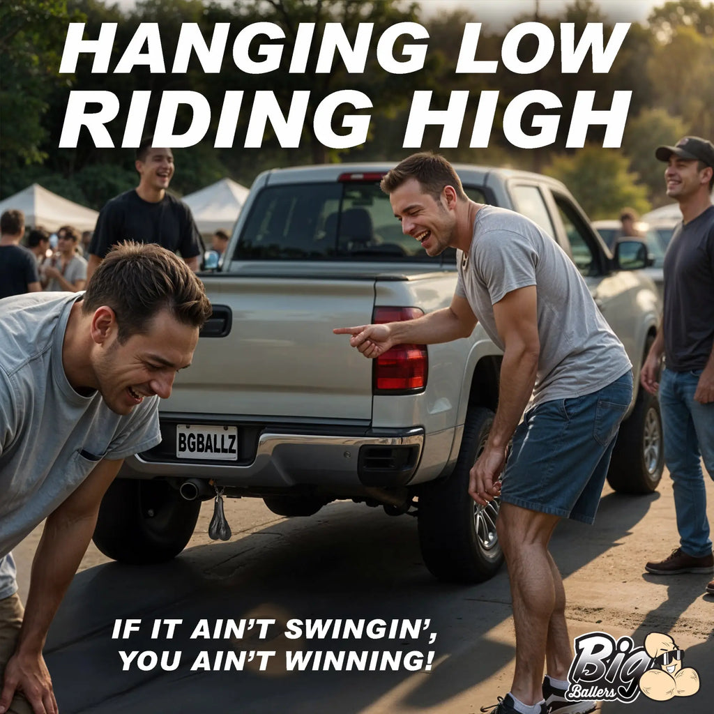 Men laughing at Big Ballers Truck Nuts, a metallic accessory hanging from the rear bumper of a light-colored pickup.