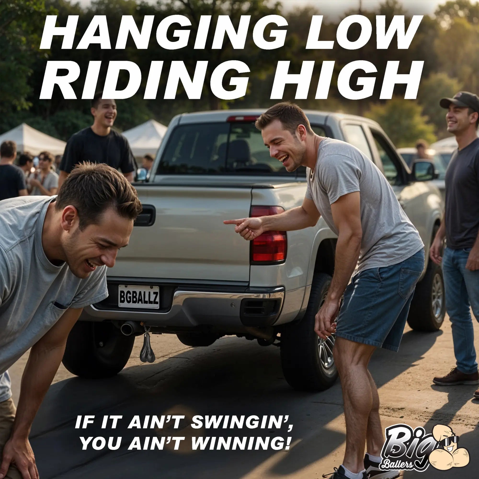 Men laughing at Big Ballers Truck Nuts, a metallic accessory hanging from the rear bumper of a light-colored pickup.