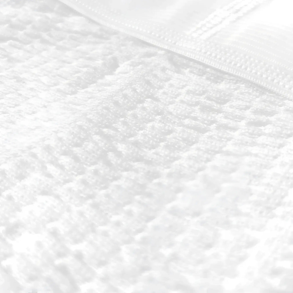 White plush terry cloth towel with woven border paired with big mans athletic supporter jockstrap product display