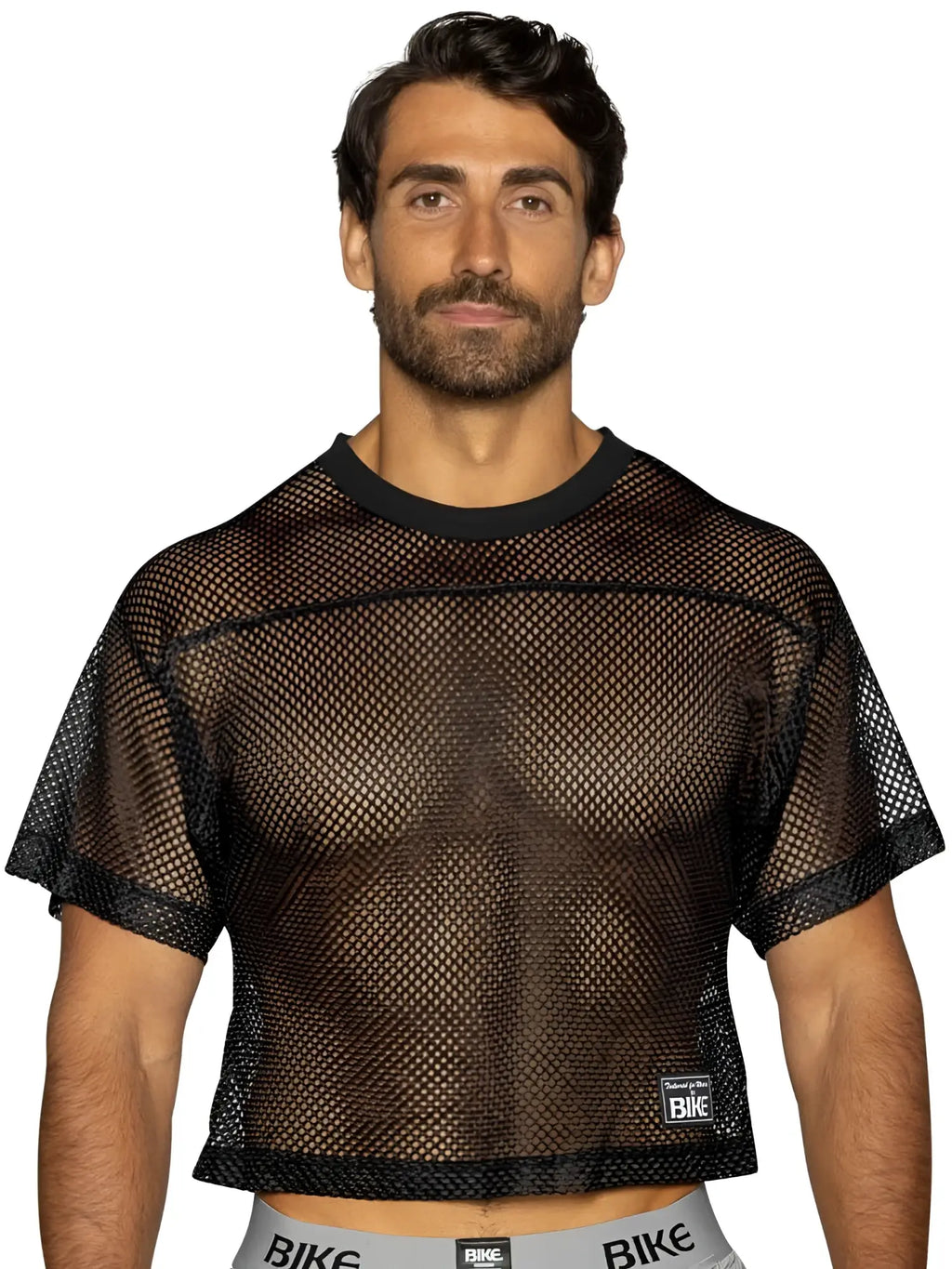 Black mesh crop top with solid ribbed neckline and hem featuring bike logo on lower right for athletic practice use