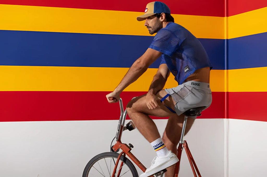 Man wearing blue royal bike athletic BAM134 mesh short sleeve practice jersey and gray bike shorts with bike branding