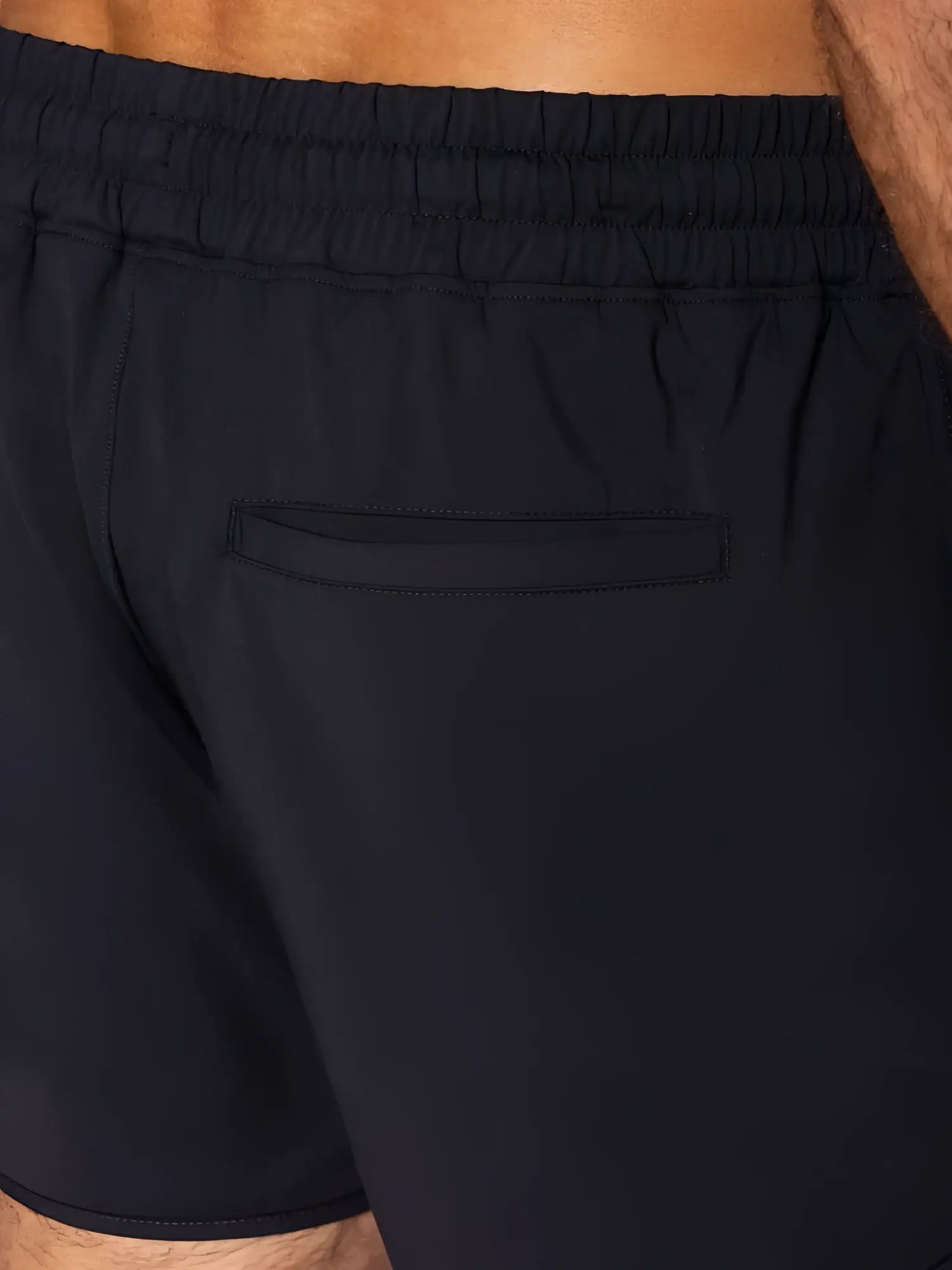 Back view of black BIKE athletic BAM200 track shorts with elastic waistband and single back pocket for running