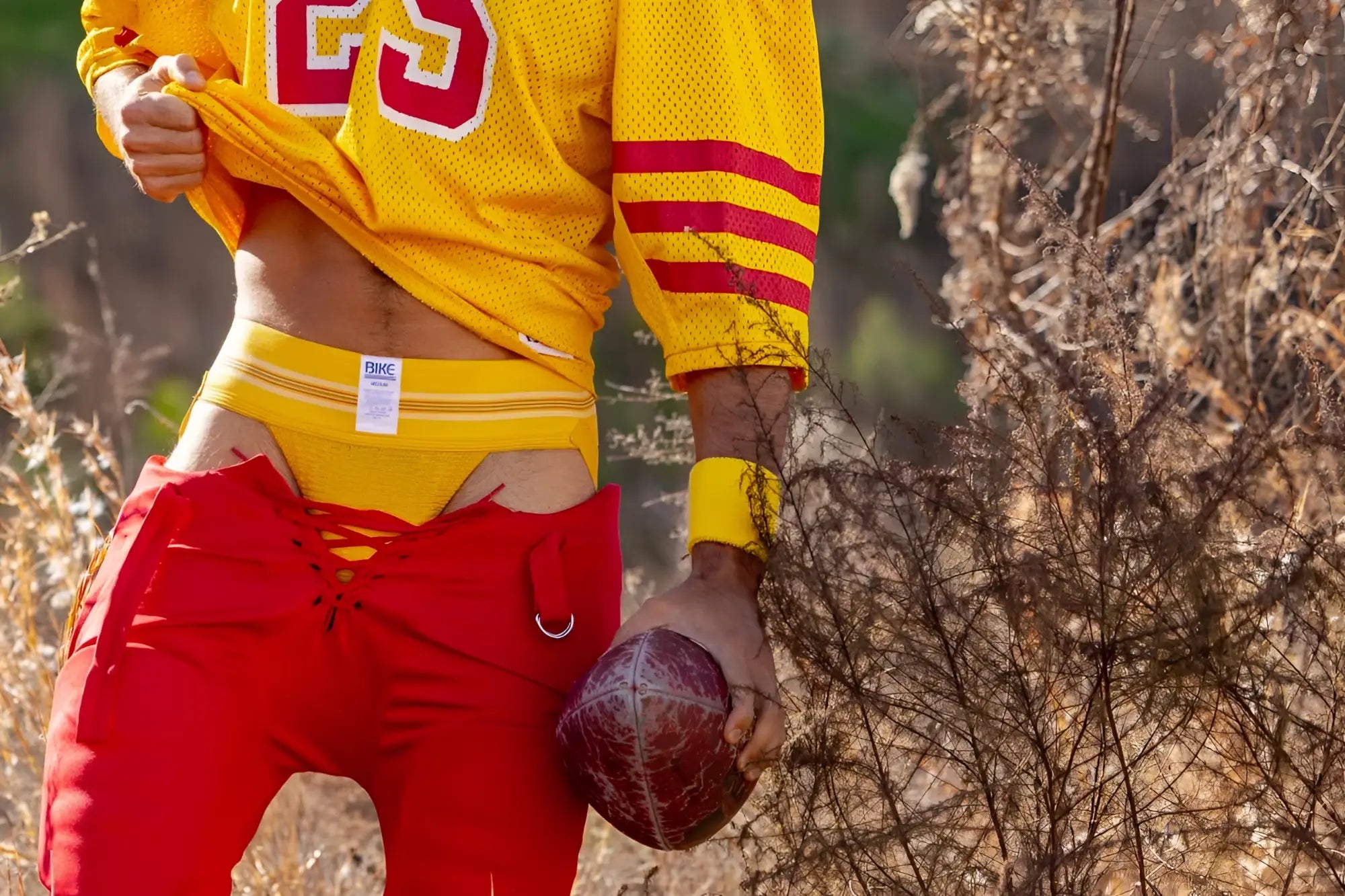 Yellow mesh football jersey with red and white number 23 on the chest by bike athletic in original yellow color