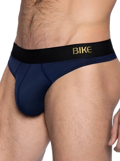 Navy blue bike brand briefs with a black waistband featuring gold lettering designed as an active thong