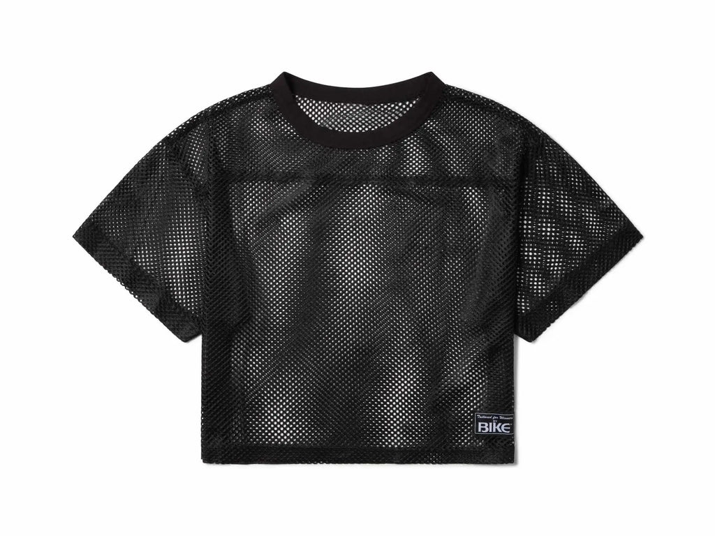Black mesh crop top bike practice jersey with round neckline short sleeves and small rectangular label on lower right side