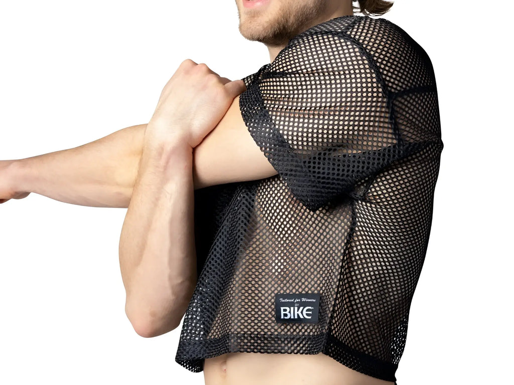 Back view of black mesh BIKE practice jersey with subtle grid pattern and branded patch on lower back