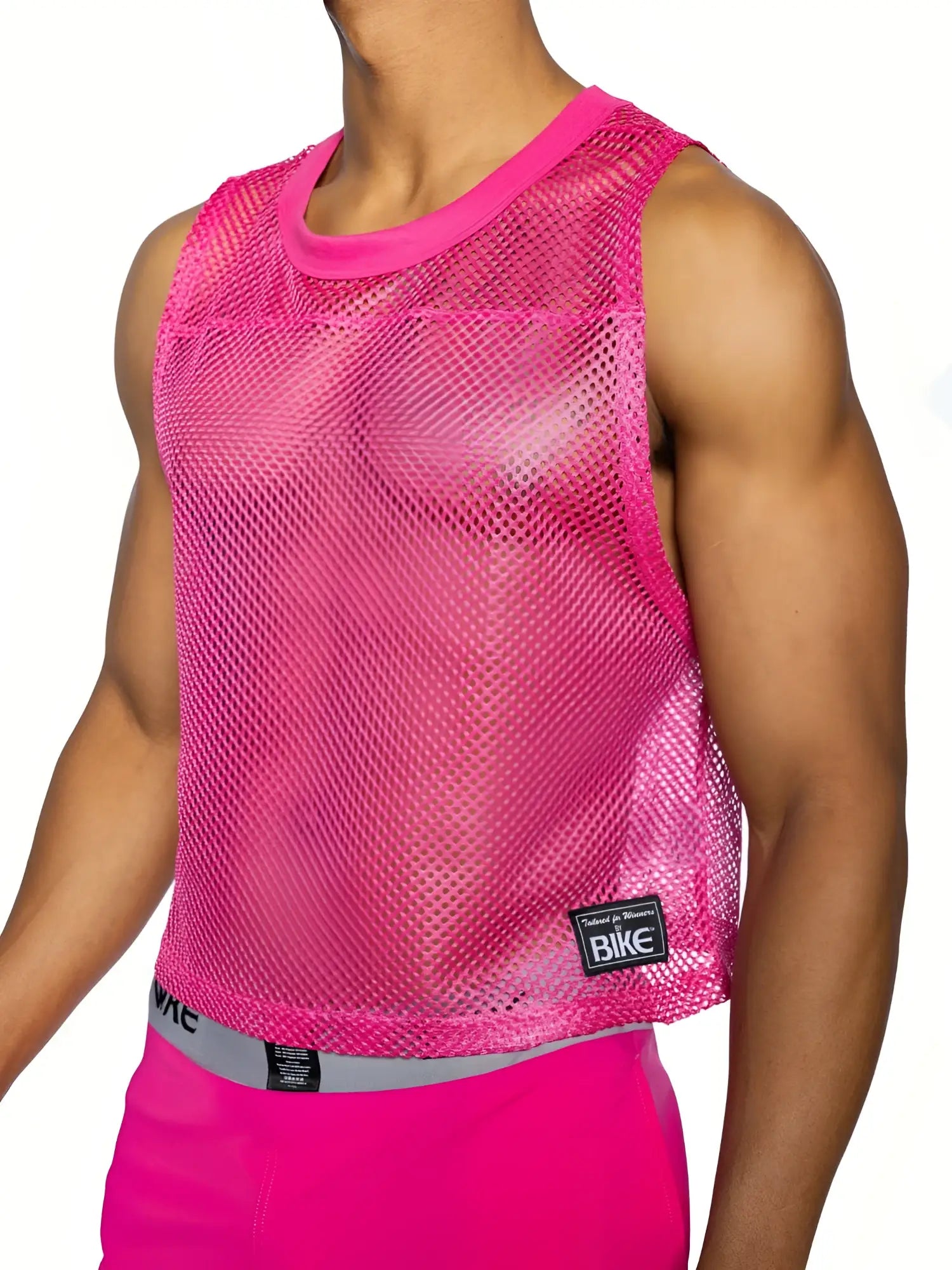 Bright pink bike sleeveless practice jersey with mesh fabric and ribbed neckline and hem in solid color