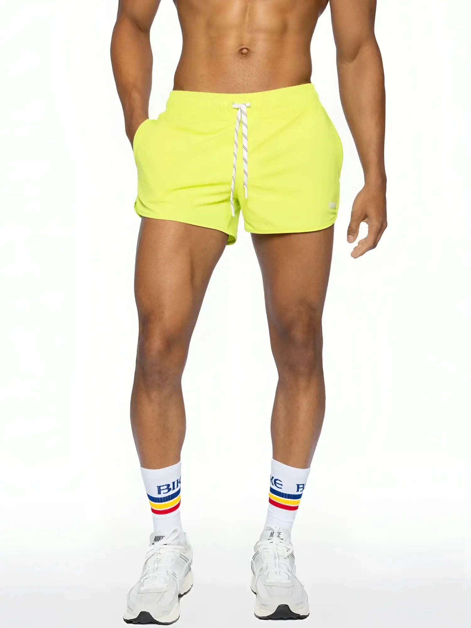 Bright neon yellow bike track shorts with white drawstring and elastic waistband for athletic use