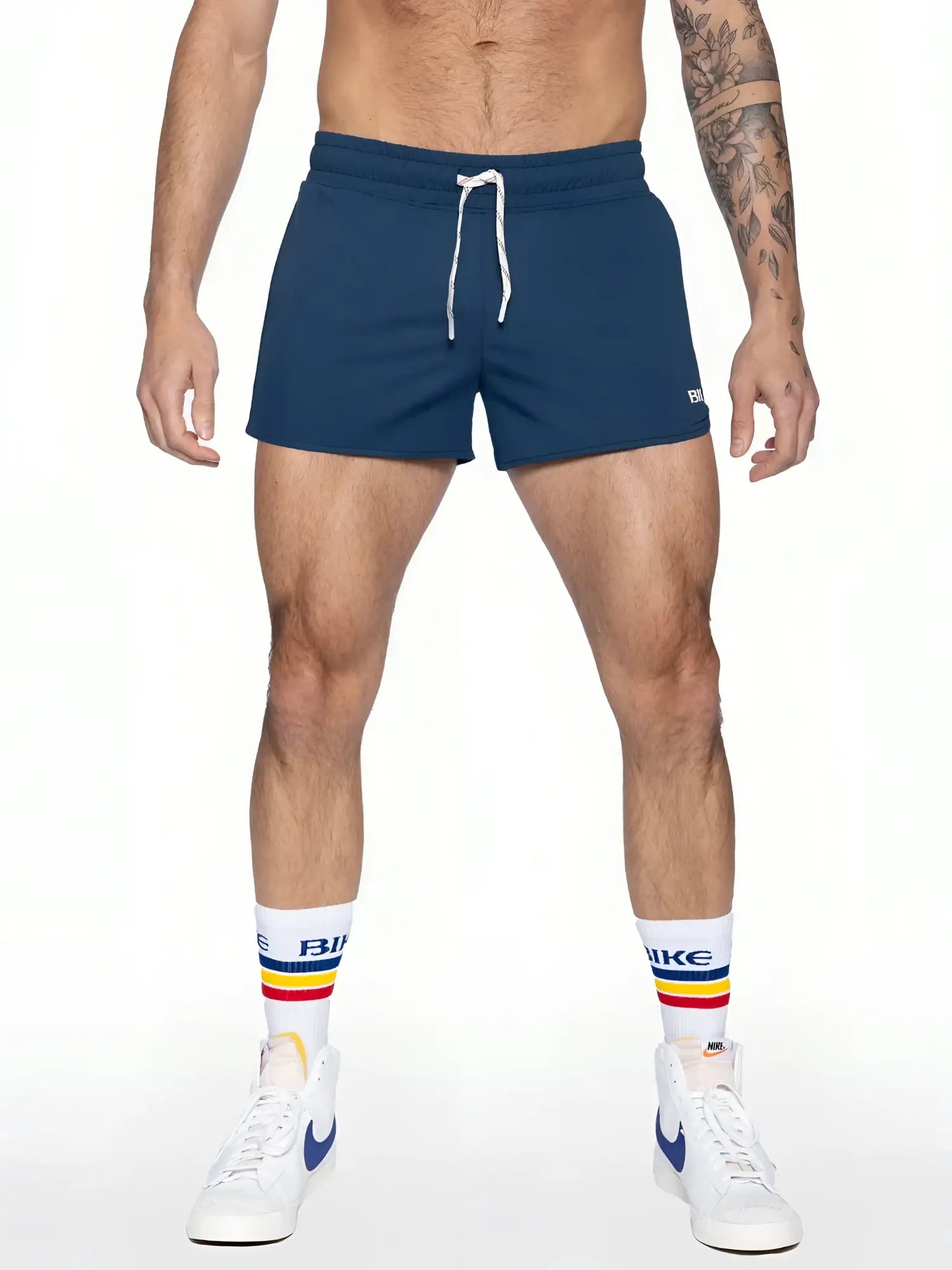 Navy blue bike track short with white drawstrings and small logo on lower right leg made for athletic use