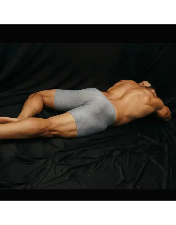 Men's compression cycling shorts in gray featuring a fitted design and breathable material shown on a model by Arroyman.