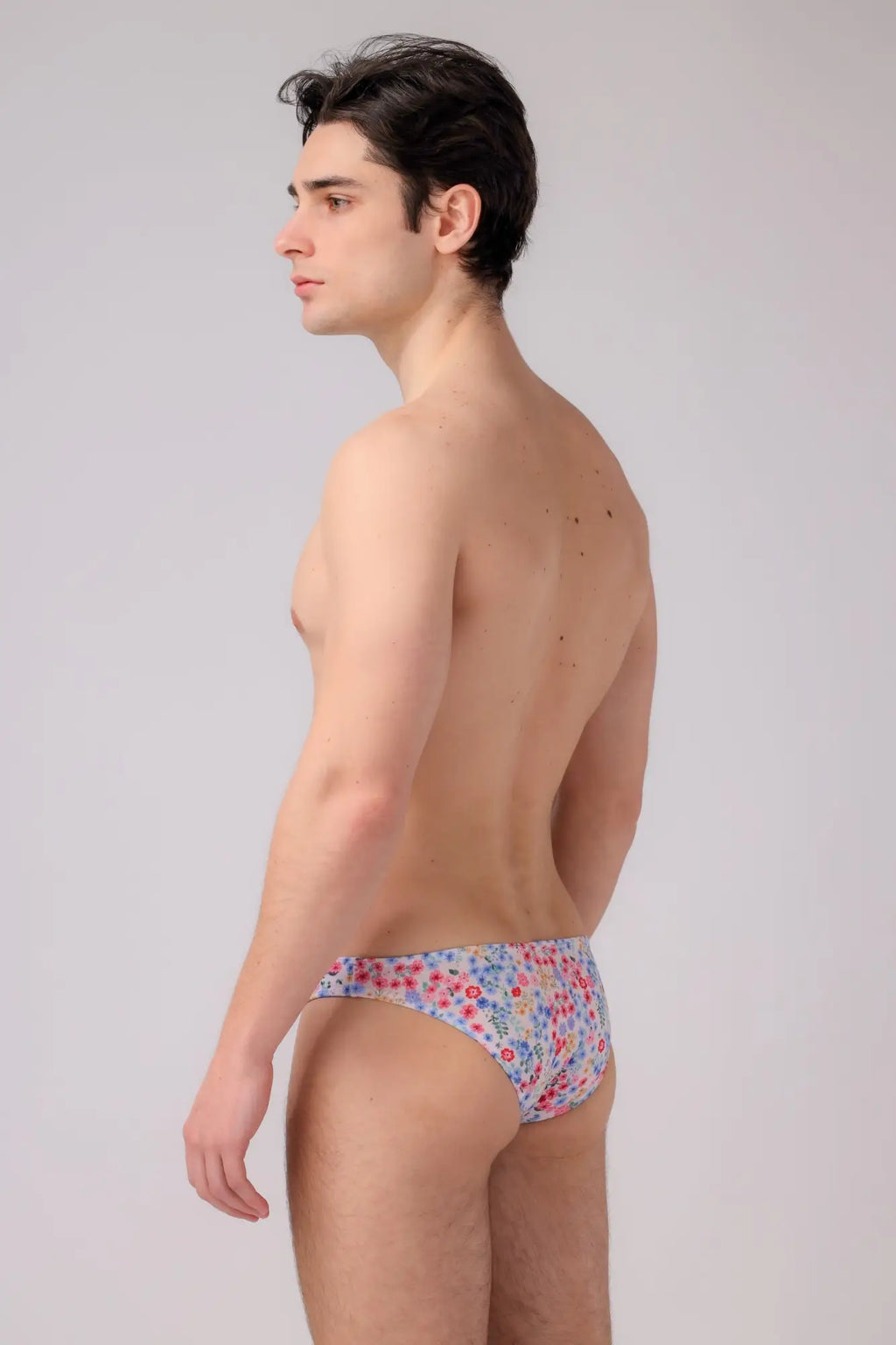 Bikini briefs with a delicate floral pattern in soft pastel hues made from lightweight fabric with elastic waistband