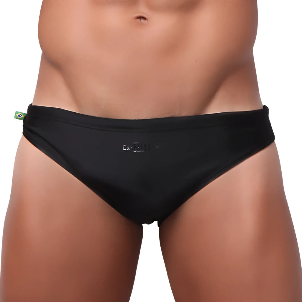 Black bikini cut solids colors sunga male bathing suit with subtle logo and brazilian flag tag on waistband