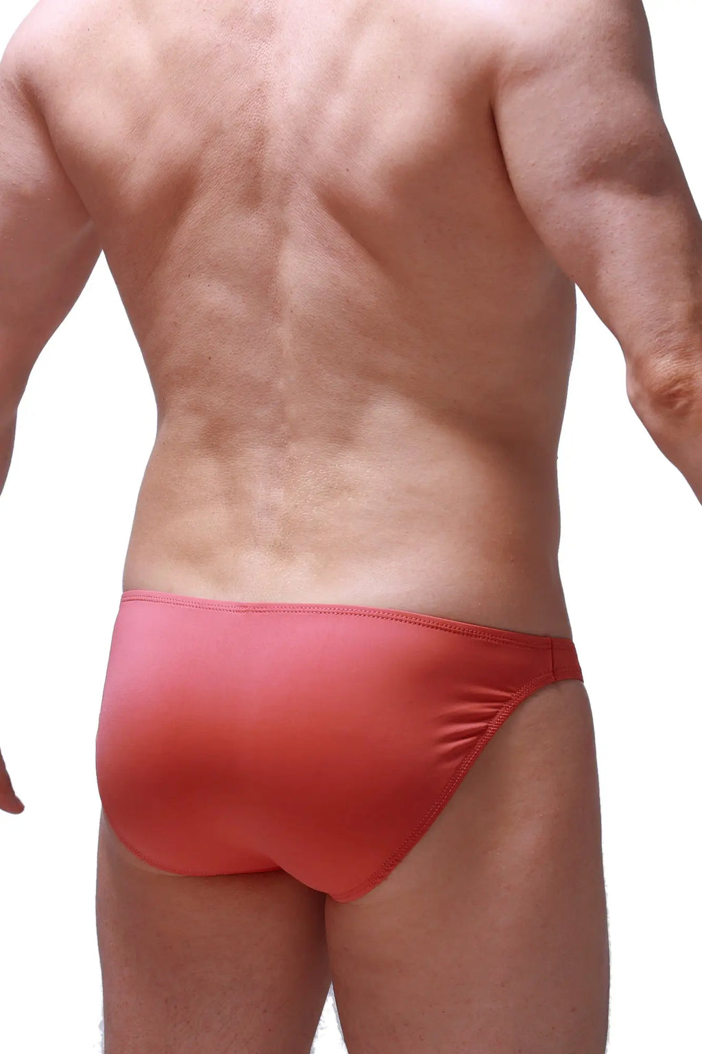 Red form-fitting bikini dome blush swim trunks with smooth stretchy fabric and subtle gradient finish