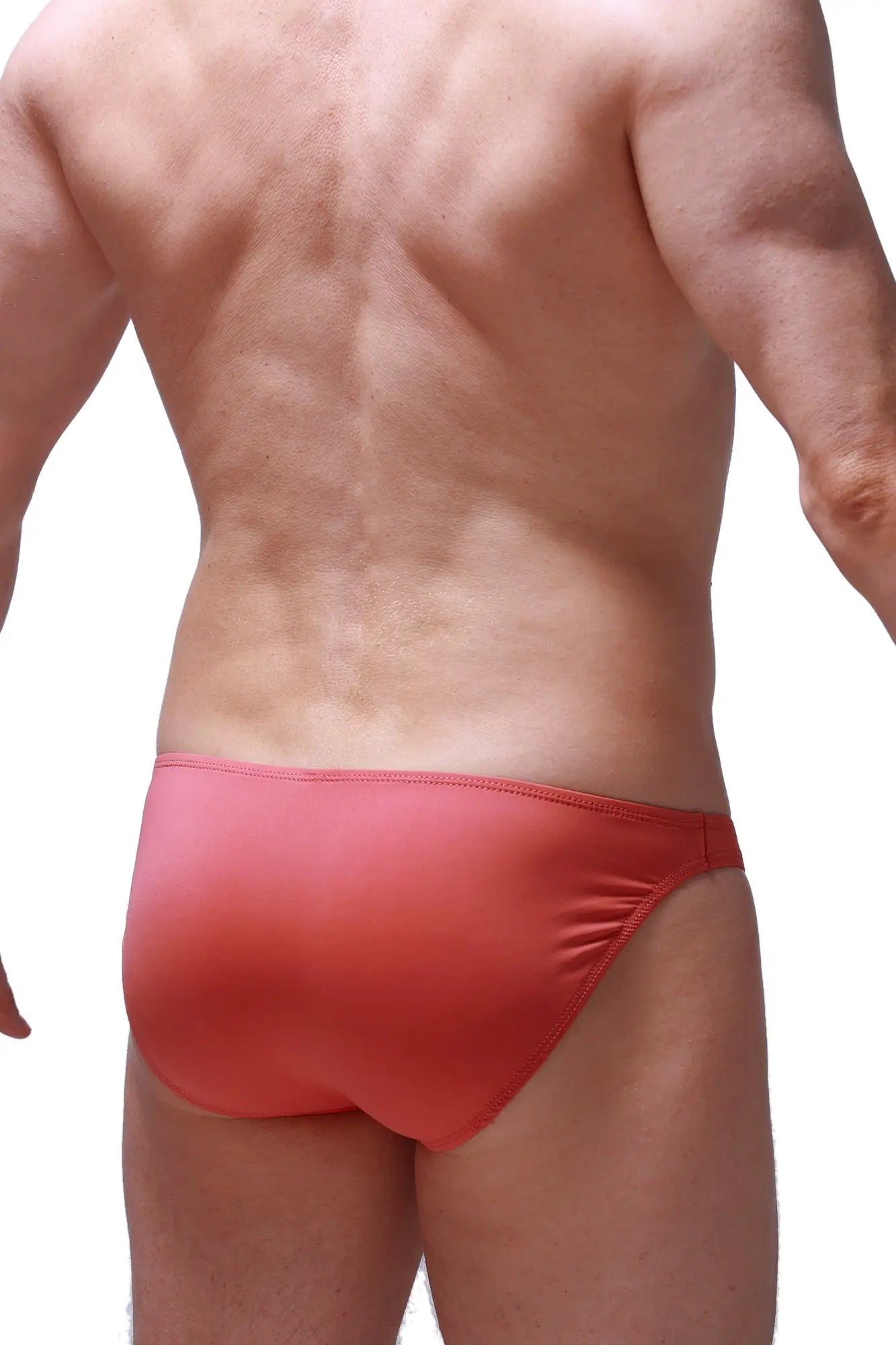 Red form-fitting bikini dome blush swim trunks with smooth stretchy fabric and subtle gradient finish