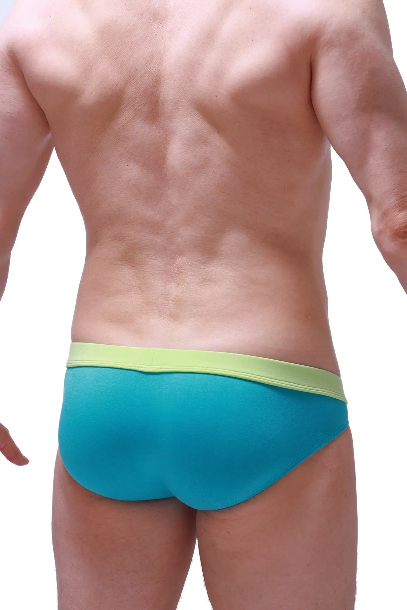 Turquoise and lime green bikini manlay tropical green swim trunks with a snug, form-fitting design