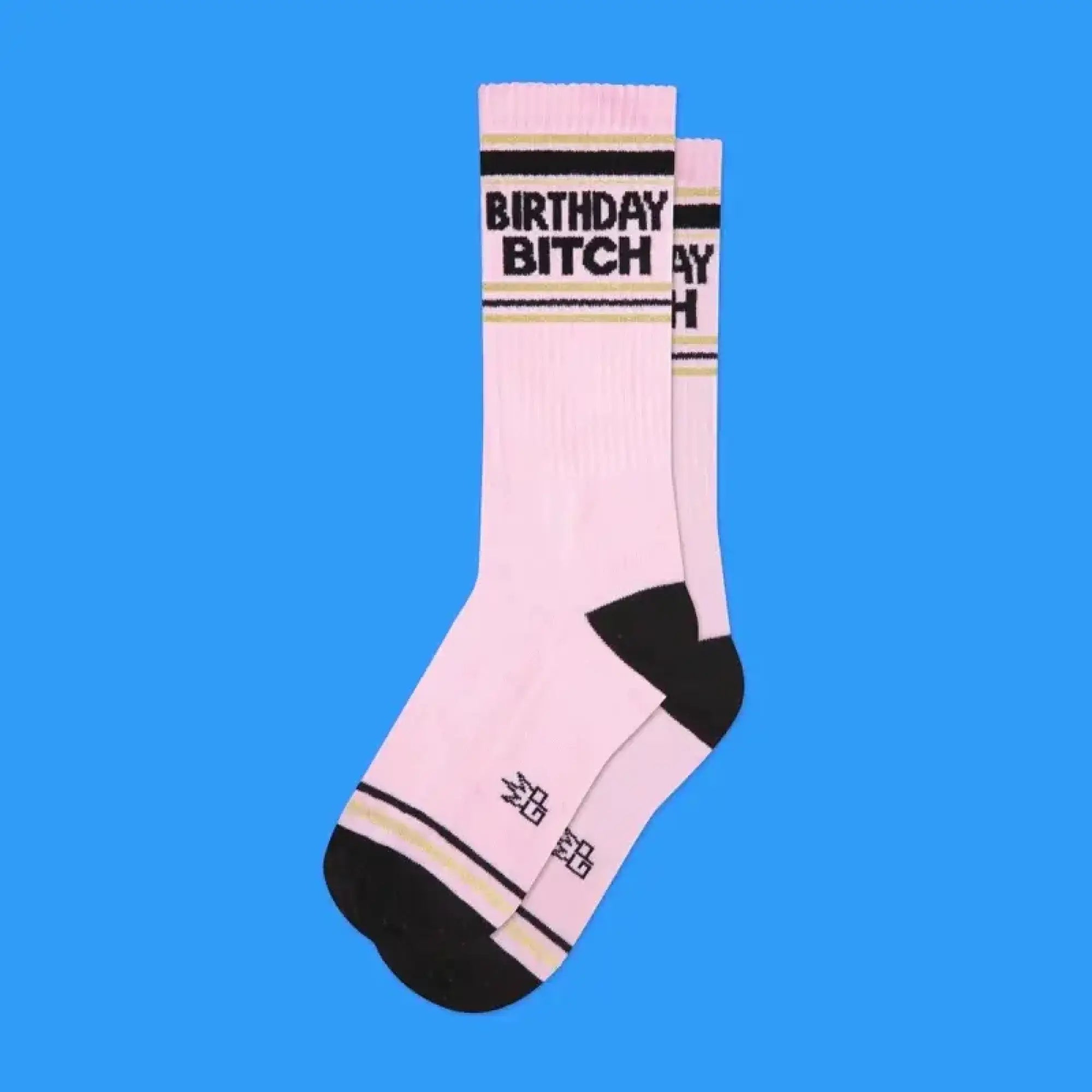 Pink birthday bitch crew socks with black toe and heel ribbed cuff gold stripe accent bold text design