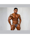 Model wearing black leopard print thong underwear by Arroyman showcasing a fitted design and bold pattern.
