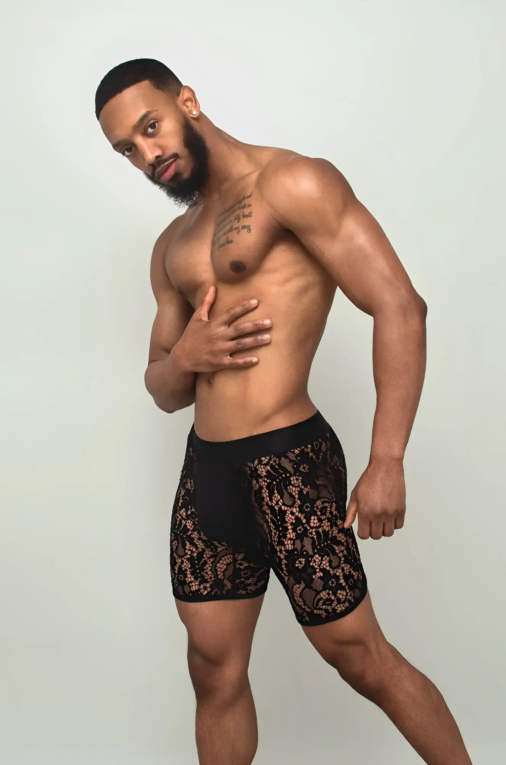 Black sheer lace boxer brief in black lace with intricate floral patterns shown from the front