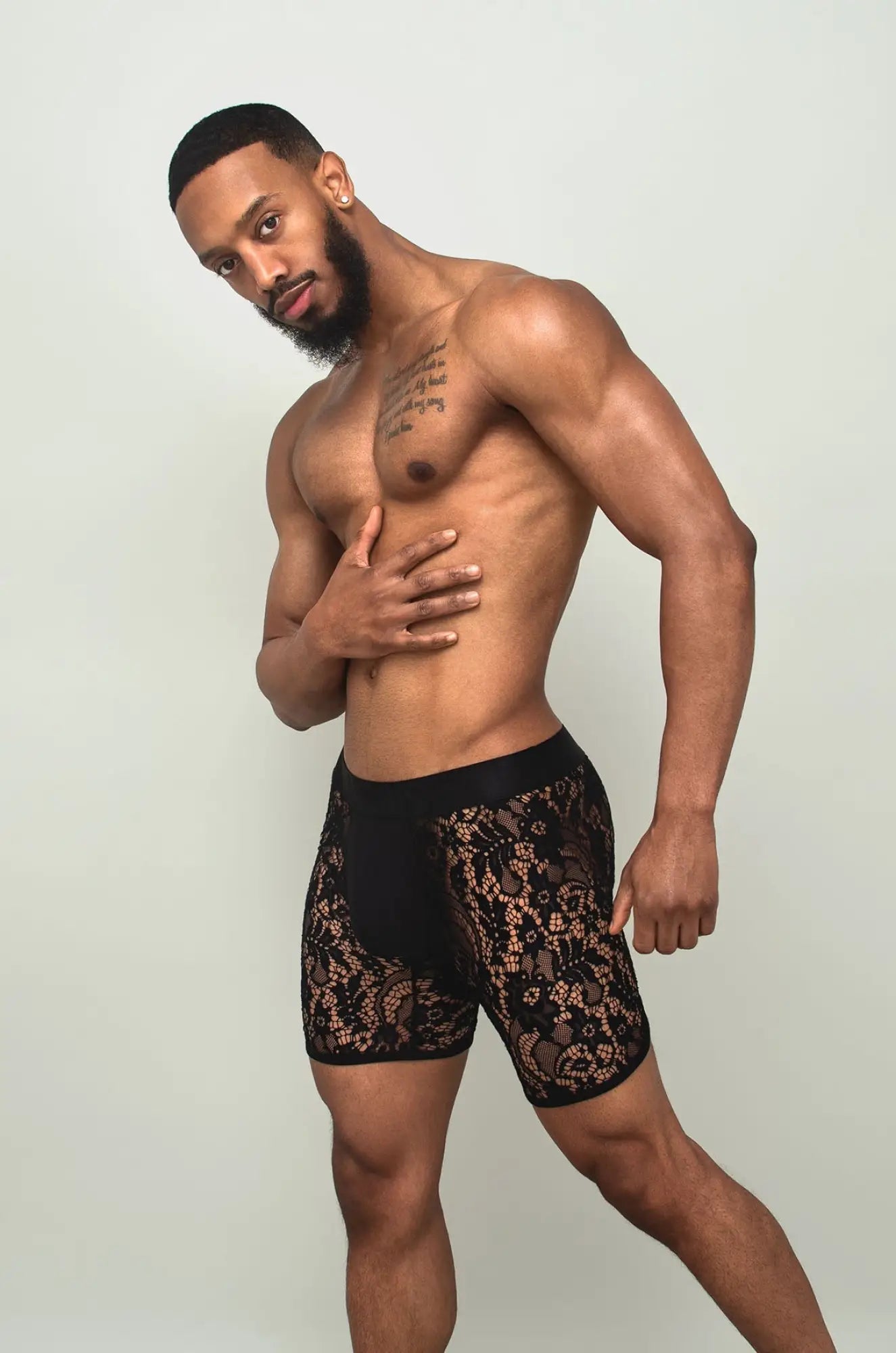 Black sheer lace boxer brief in black lace with intricate floral patterns shown from the front