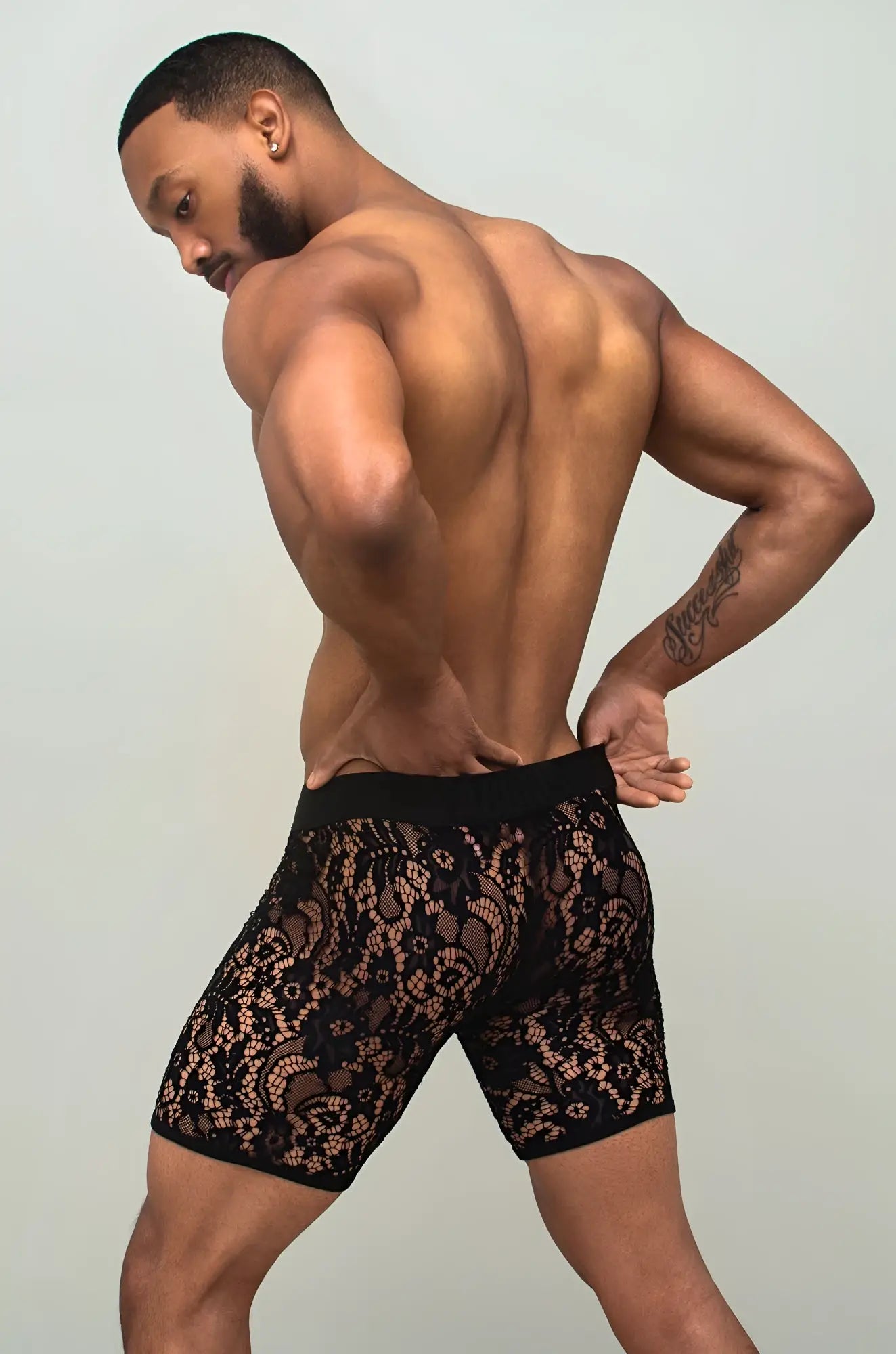 Black sheer lace boxer brief in black lace with a delicate intricate pattern visible in front side view