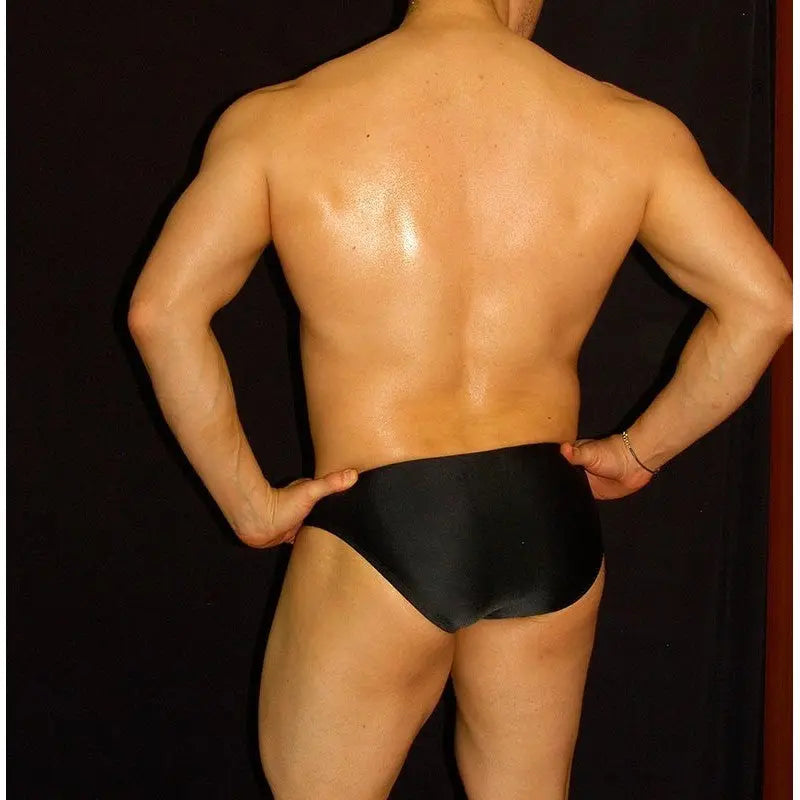 Men's black bikini swimwear by Arroyman featuring a sleek design and comfortable fit shown on a model from the back.