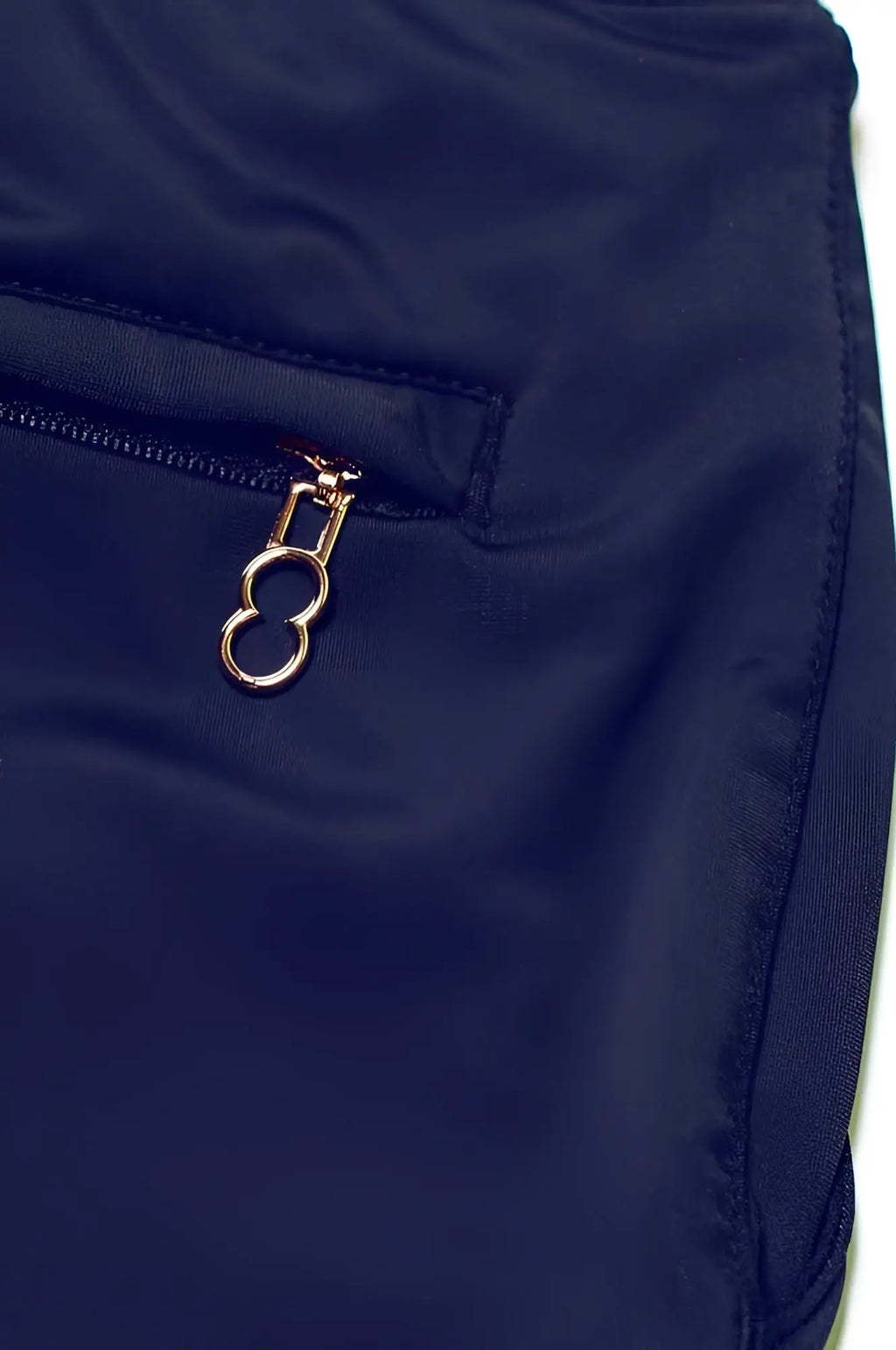 Navy blue nylon bondi short featuring a gold-toned oval ring zipper pull for casual wear