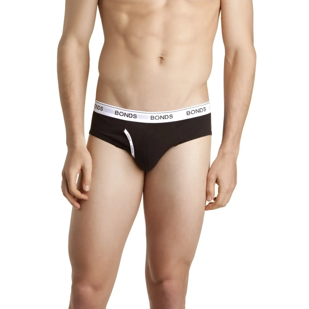 Bonds guy front brief underwear in black with white elastic waistband featuring repeated Bonds logo size L