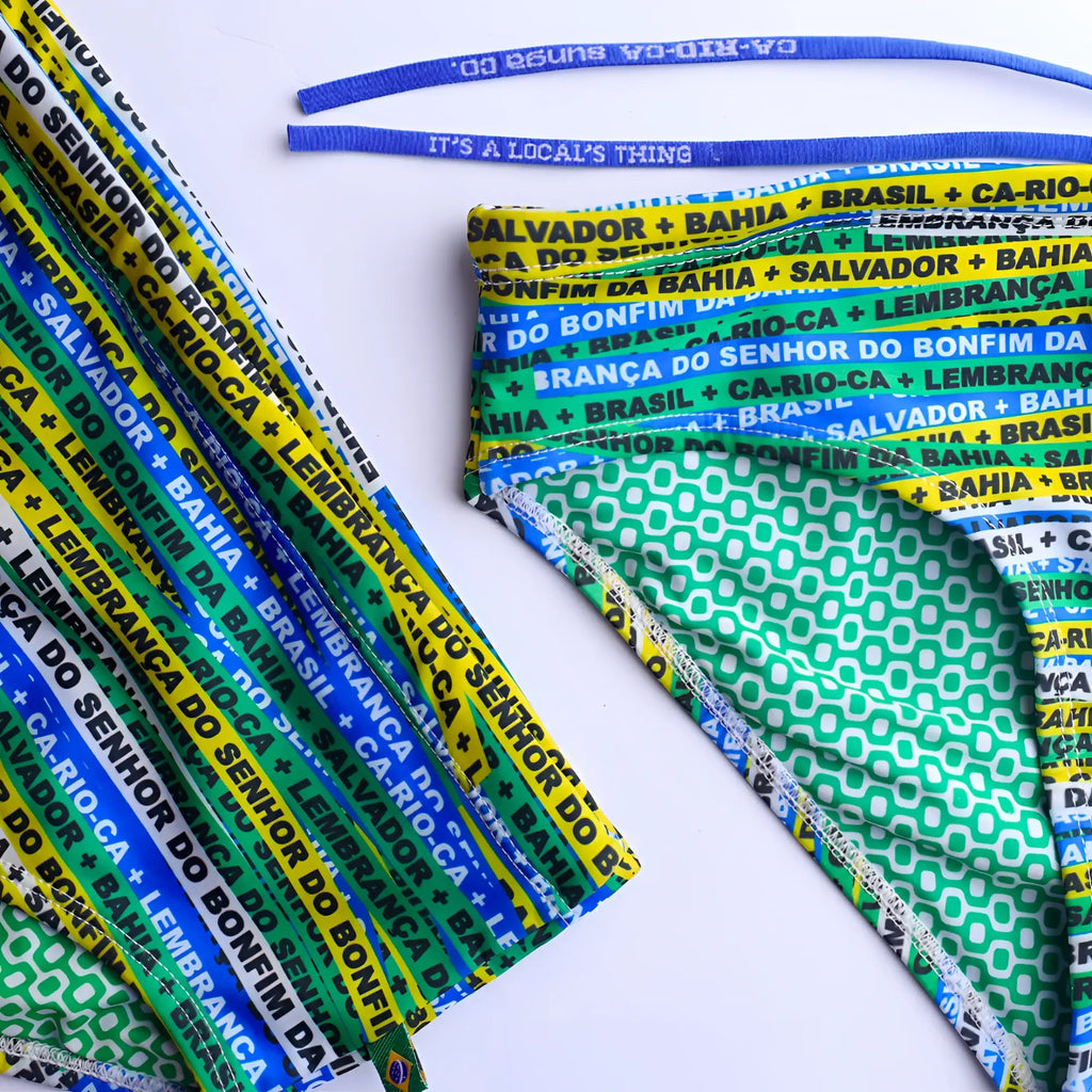 A vibrant multicolored fabric headband with green yellow and blue stripes featuring brazilian city names for men