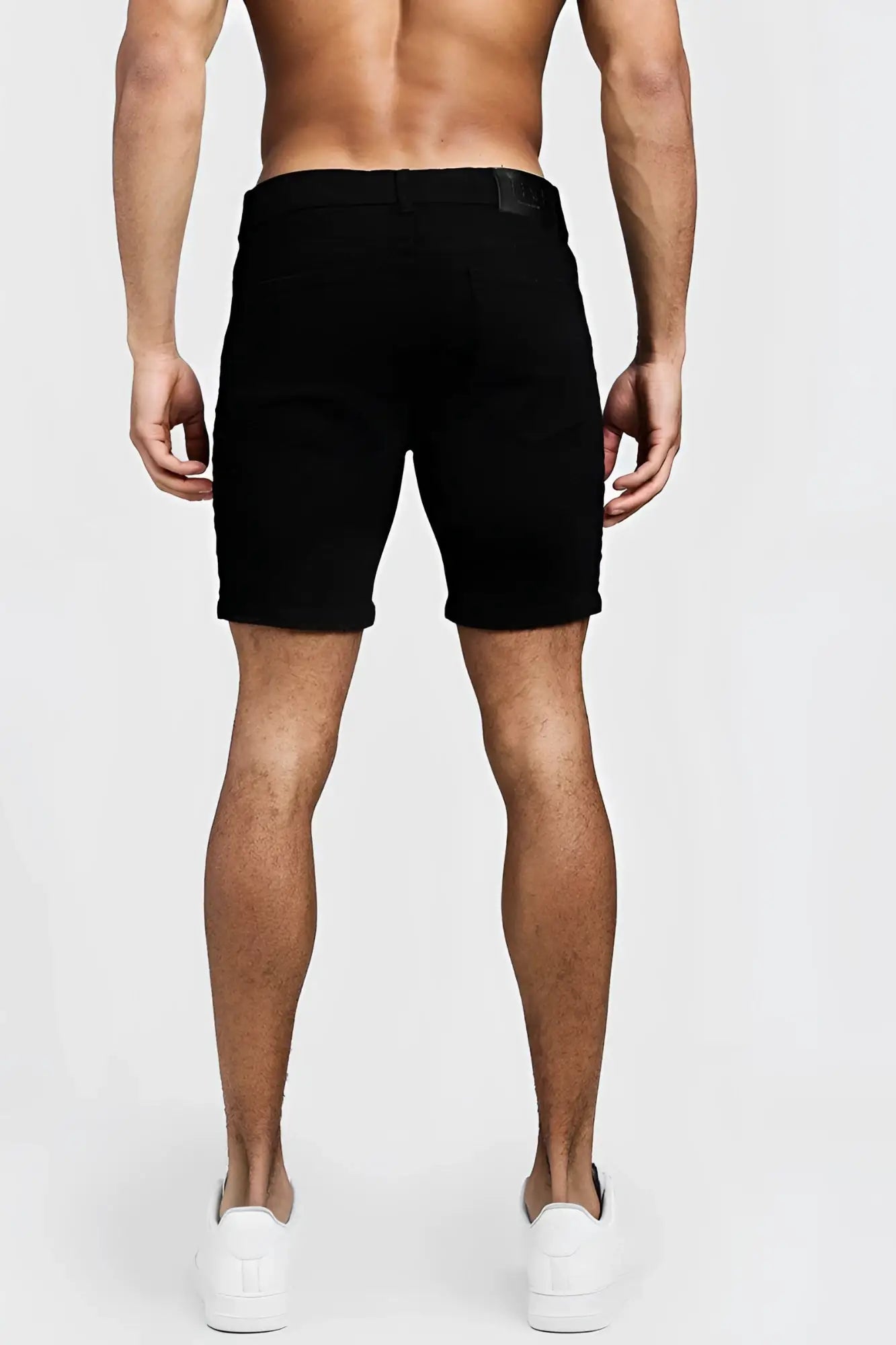 Black boohoo skinny fit denim shorts with side tape straight cut mid thigh length and subtle waistband label size 32