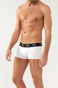 White boxer briefs with a black elastic waistband featuring repeating ac logos from the boosting soft trunks line