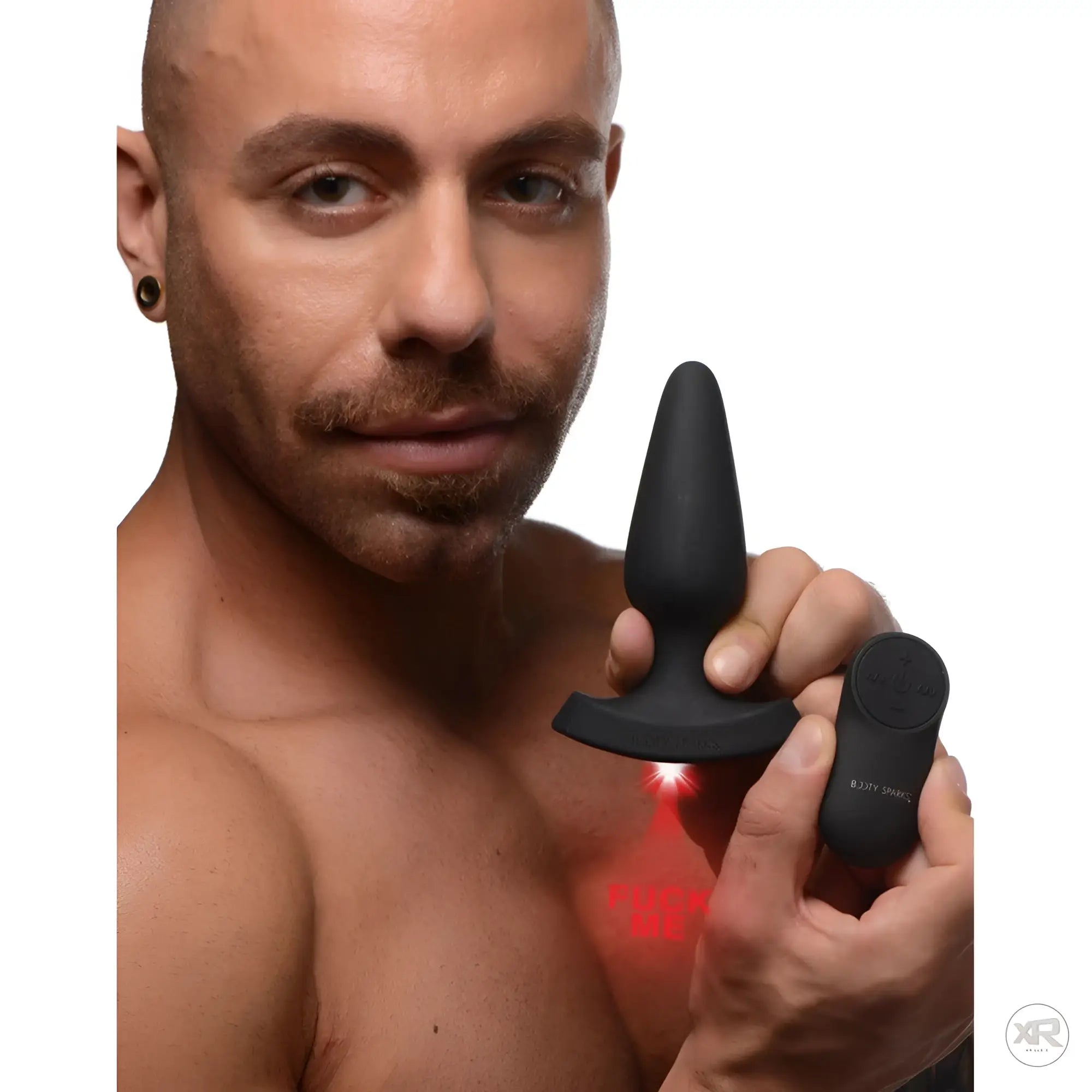Man holding a black Booty Sparks 28X laser anal plug and remote; the device projects a red "FUCK ME" text.